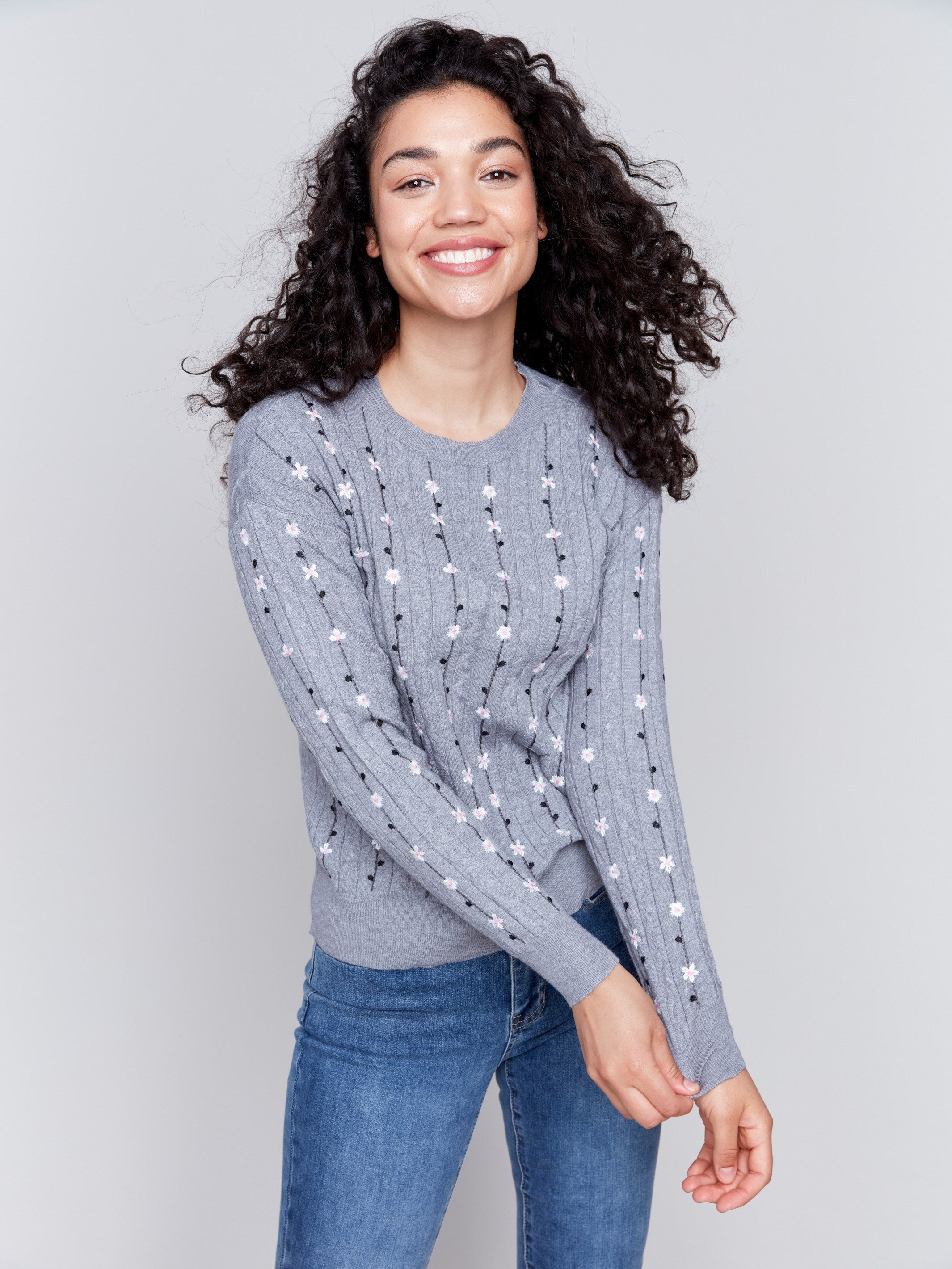 Grey plushy knit sweater with floral embroidery, crew neck, and long sleeves by Charlie B.