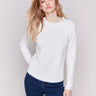 Cream white long-sleeve sweater with a crew neck and frayed rounded hem by Charlie B.