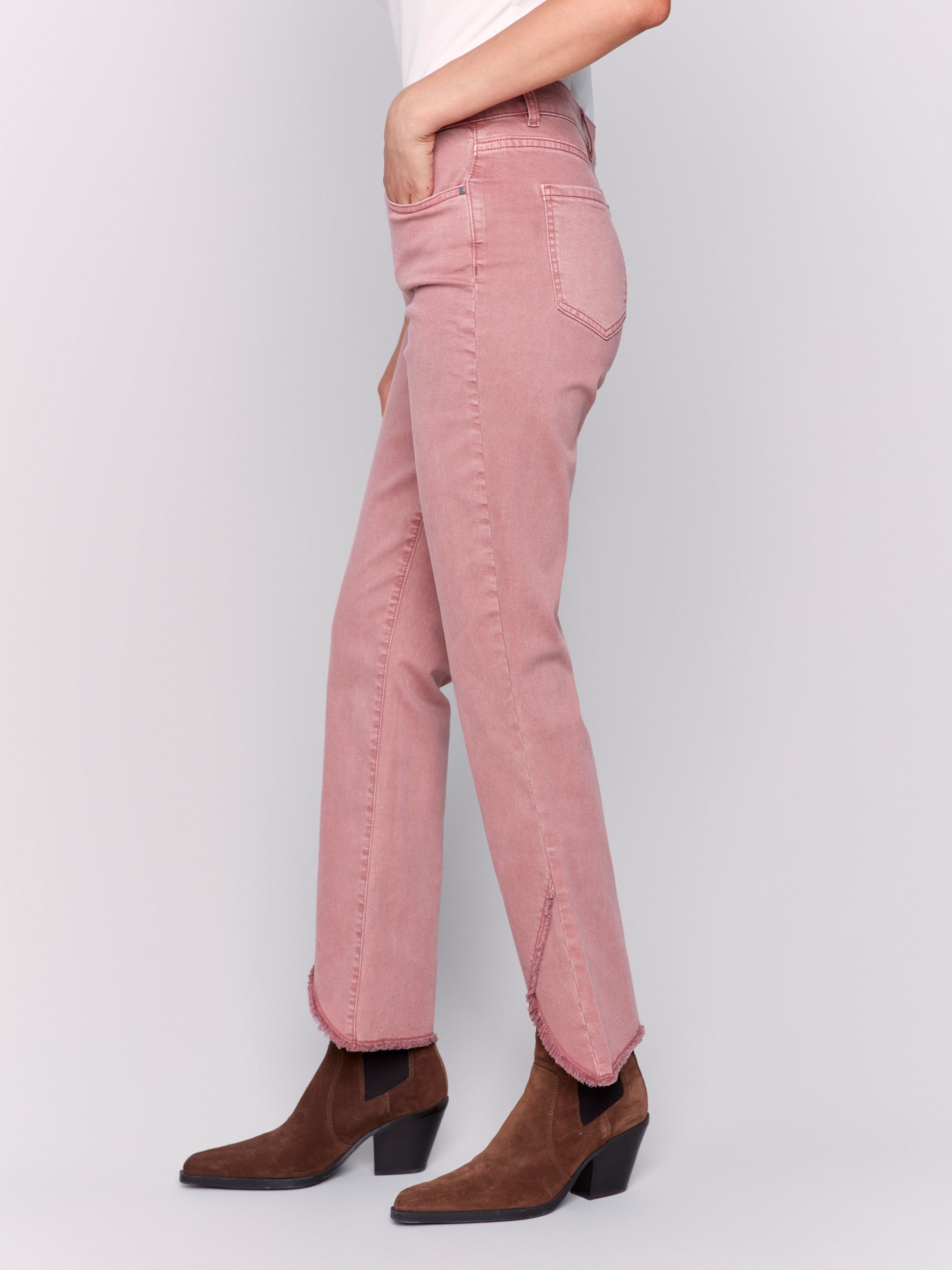 Woodrose pink front tulip hem twill pants featuring a mid-rise and bootcut leg. Unique front tulip hem detail for a stylish look by Charlie B.