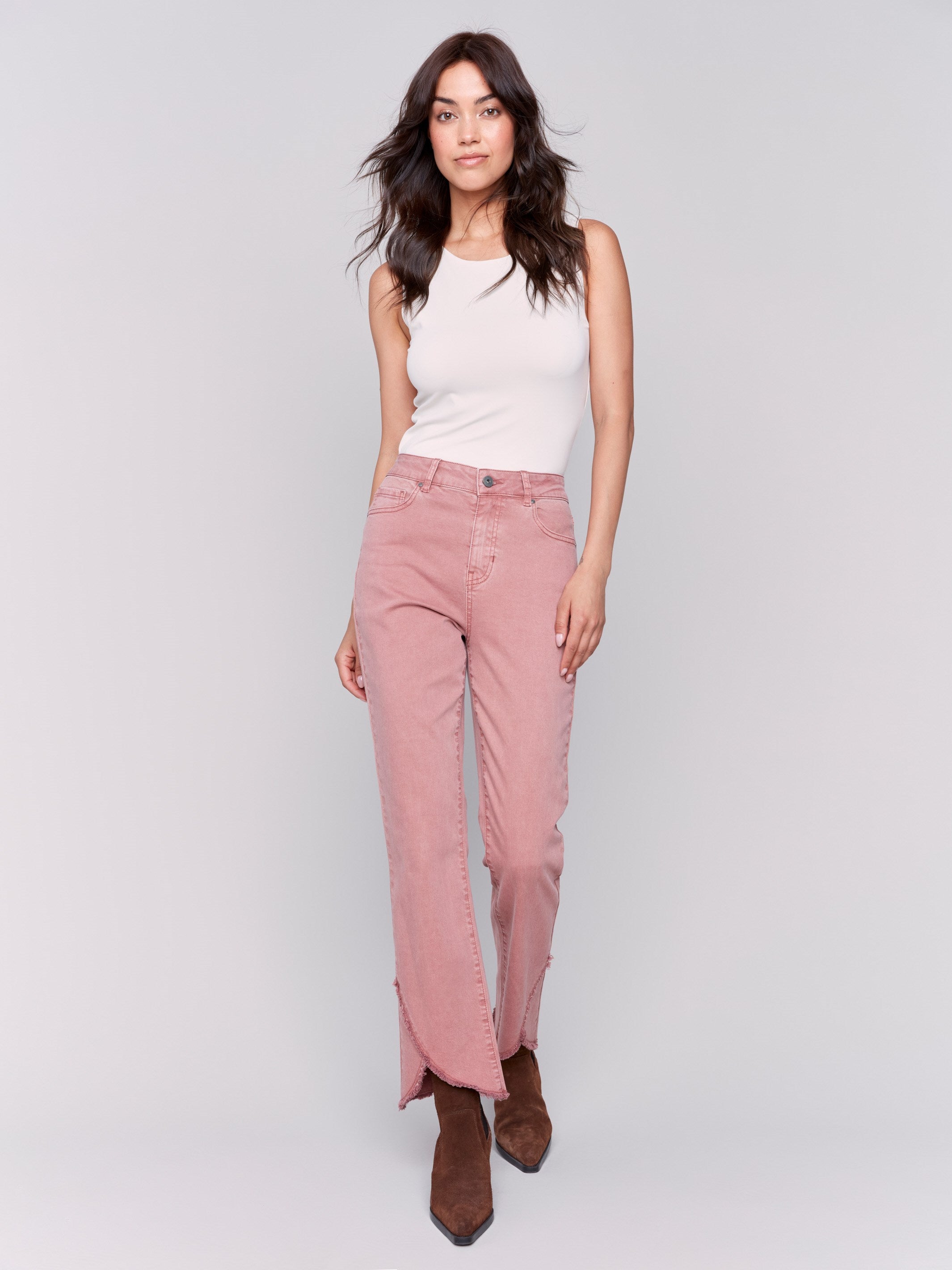 Woodrose pink front tulip hem twill pants featuring a mid-rise and bootcut leg. Unique front tulip hem detail for a stylish look by Charlie B.