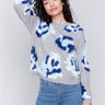 Light grey fuzzy jacquard knit sweater with a floral blue pattern, featuring a crew neck and drop-shoulder design by Charlie B.