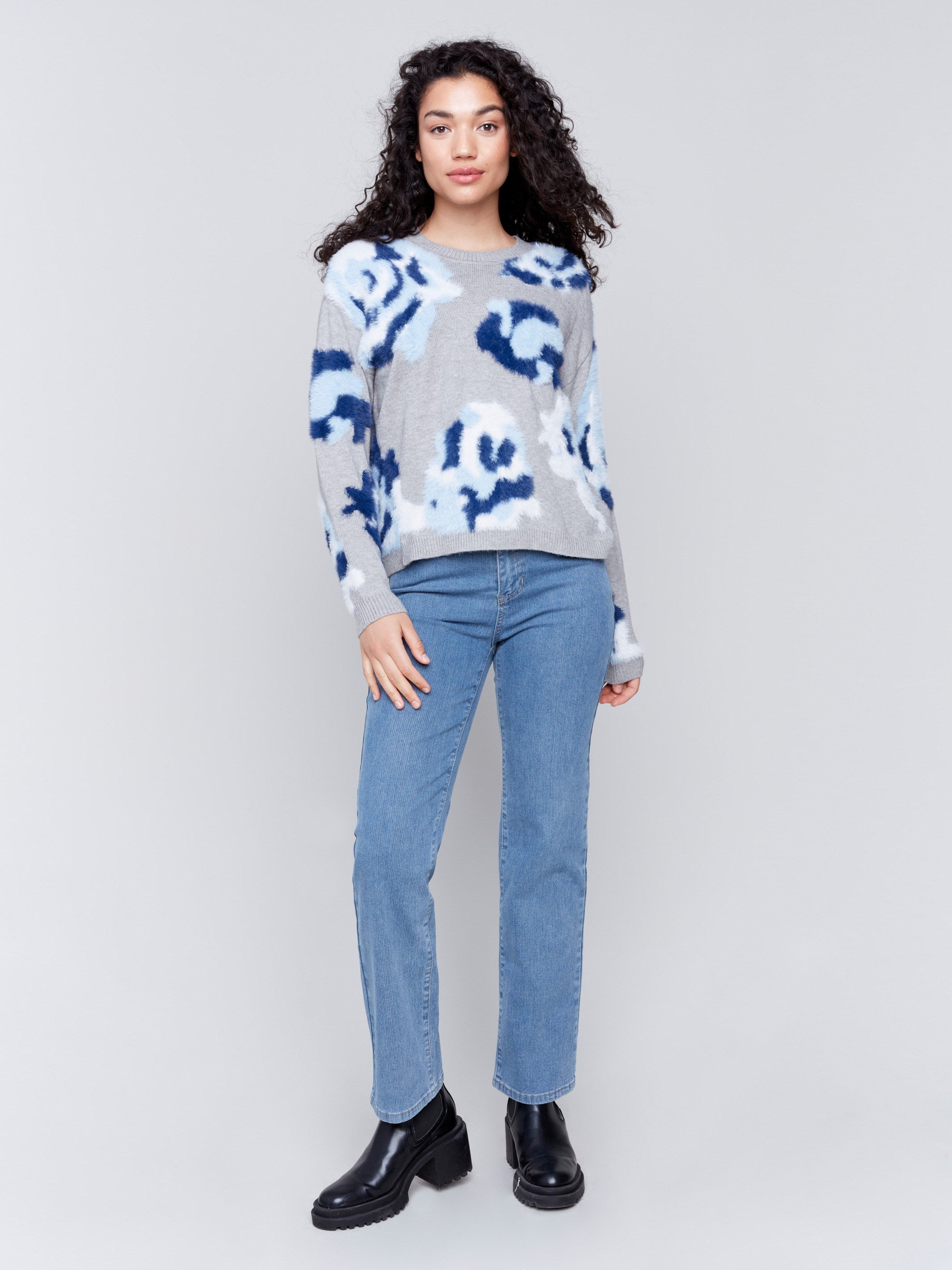 Light grey fuzzy jacquard knit sweater with a floral blue pattern, featuring a crew neck and drop-shoulder design by Charlie B.