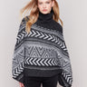 Charcoal poncho with a geometric jacquard pattern, featuring a cozy cowl neck and buttoned sleeves by Charlie B.