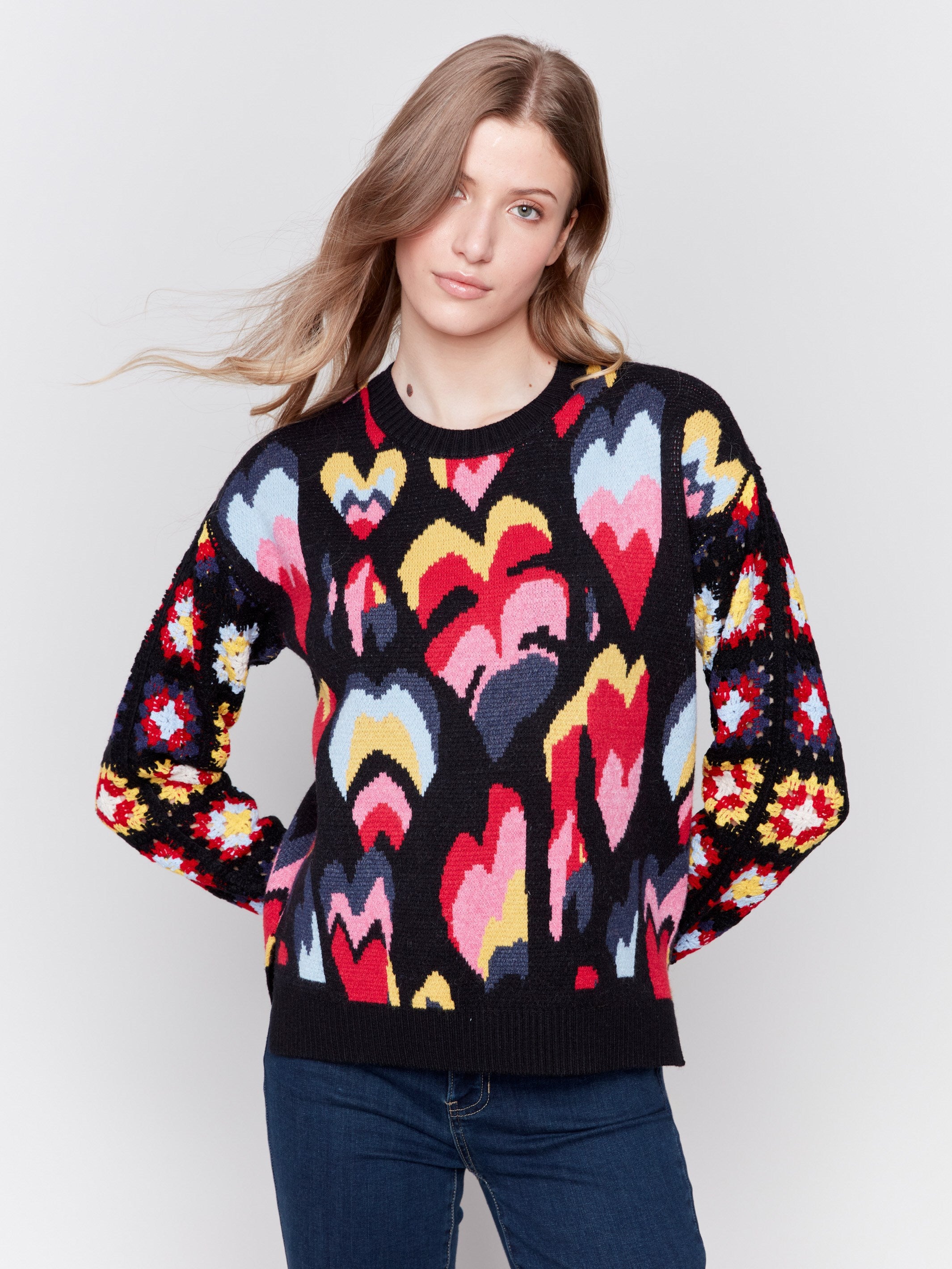 Black jacquard sweater with colorful pattern, featuring crochet sleeves and ribbed cuffs by Charlie B.