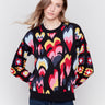 Black jacquard sweater with colorful pattern, featuring crochet sleeves and ribbed cuffs by Charlie B.