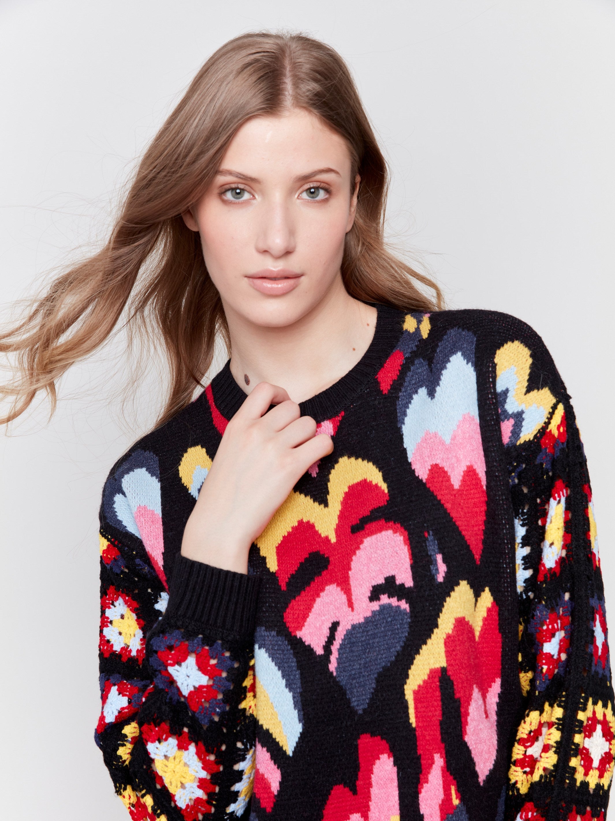 Black jacquard sweater with colorful pattern, featuring crochet sleeves and ribbed cuffs by Charlie B.