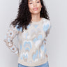 Beige jacquard sweater with blue and brown pattern, featuring crochet sleeves and ribbed cuffs by Charlie B.