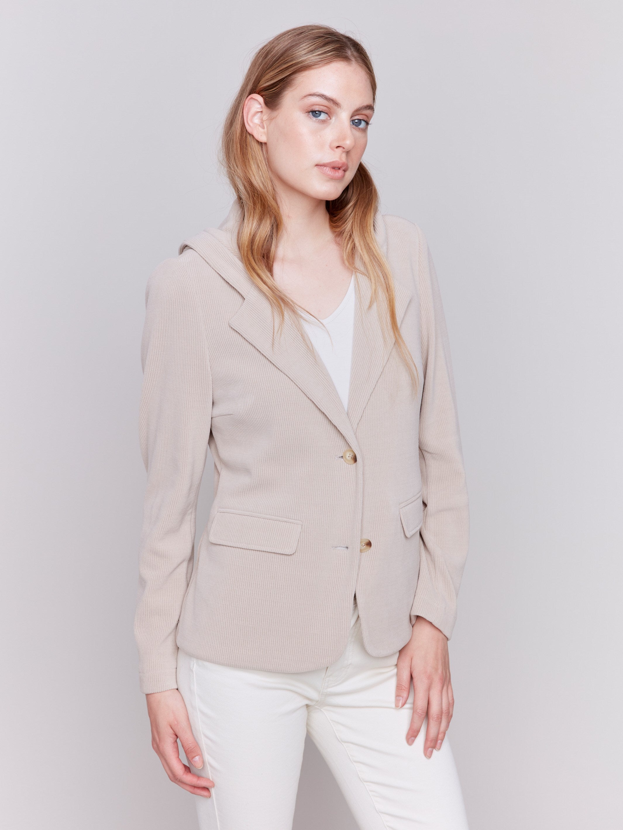 Almond-colored corduroy blazer with a hood, featuring two button closure, tailored fit, and two front flap pockets by Charlie B.