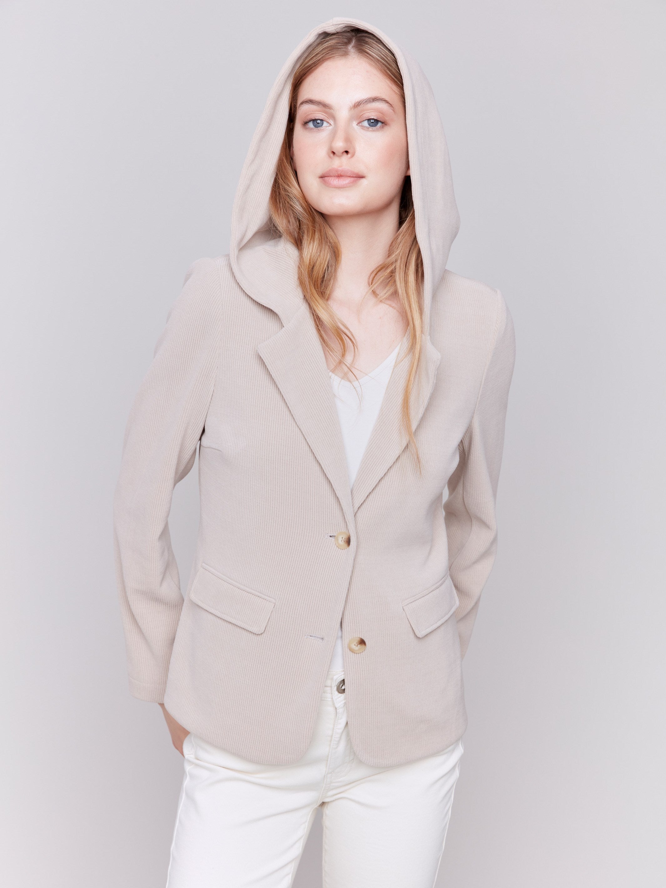 Almond-colored corduroy blazer with a hood, featuring two button closure, tailored fit, and two front flap pockets by Charlie B.