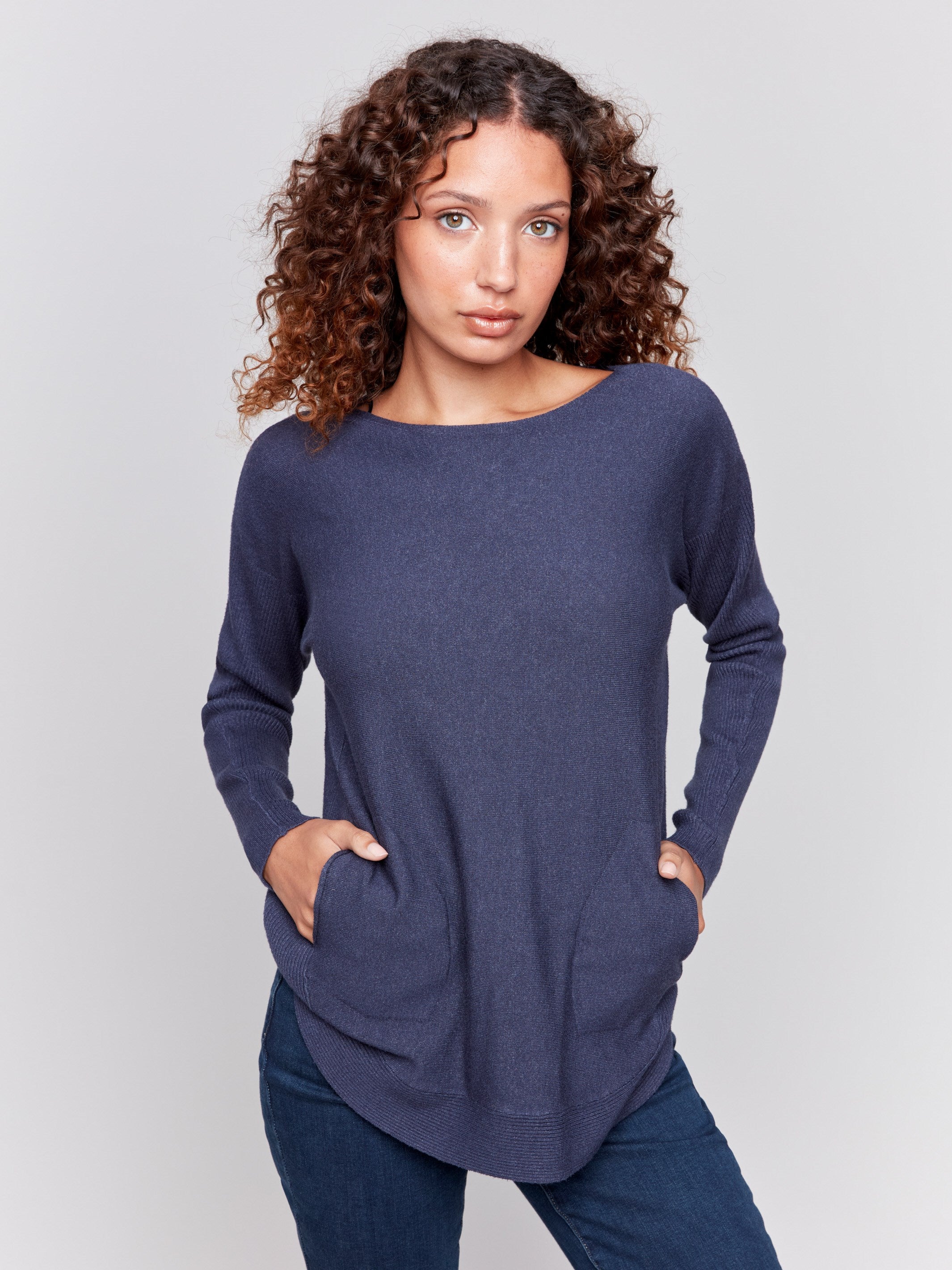 Dark blue knit sweater with a crew neckline, long ribbed sleeves, and back lace-up eyelet details by Charlie B.