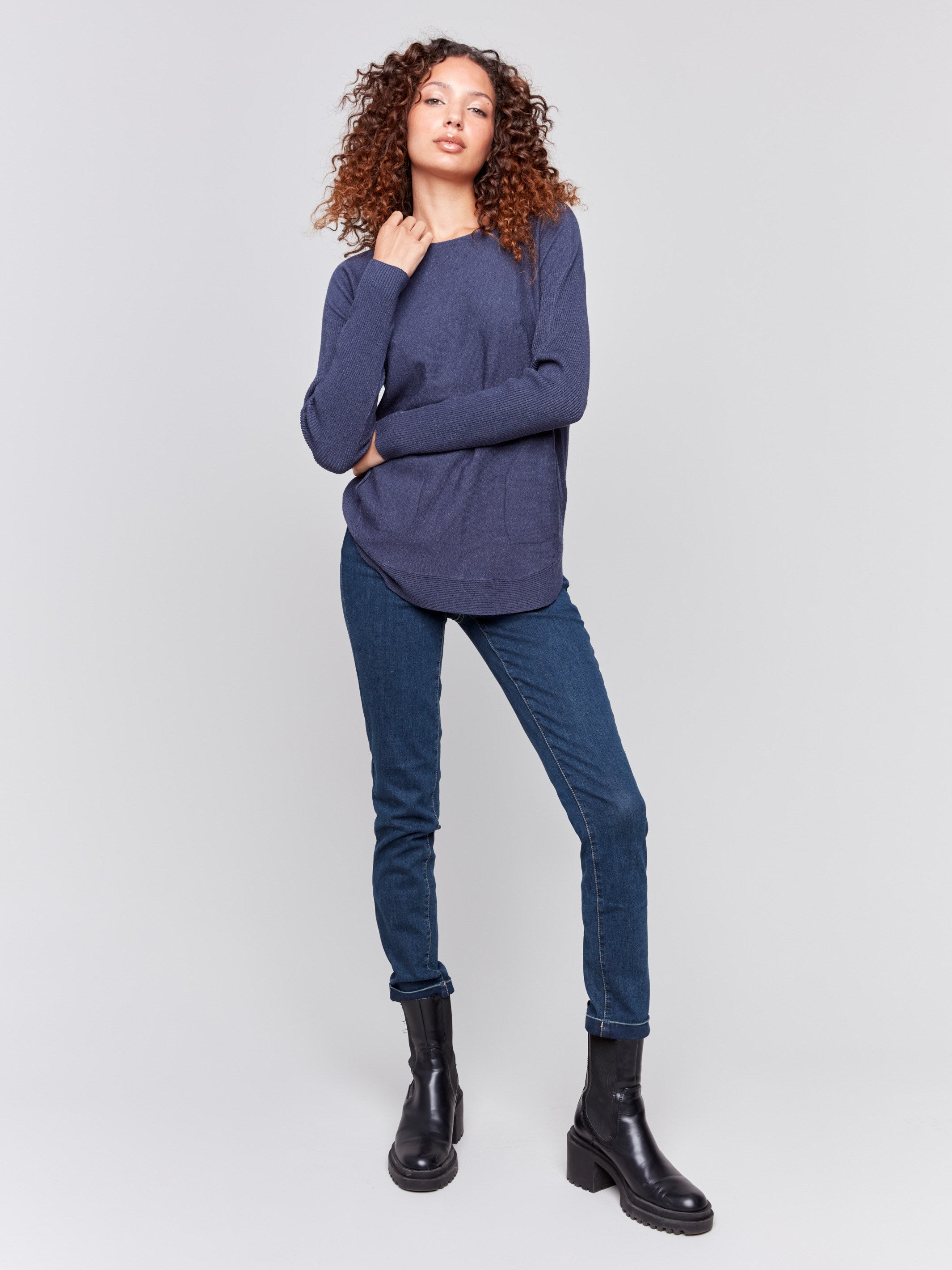 Dark blue knit sweater with a crew neckline, long ribbed sleeves, and back lace-up eyelet details by Charlie B.