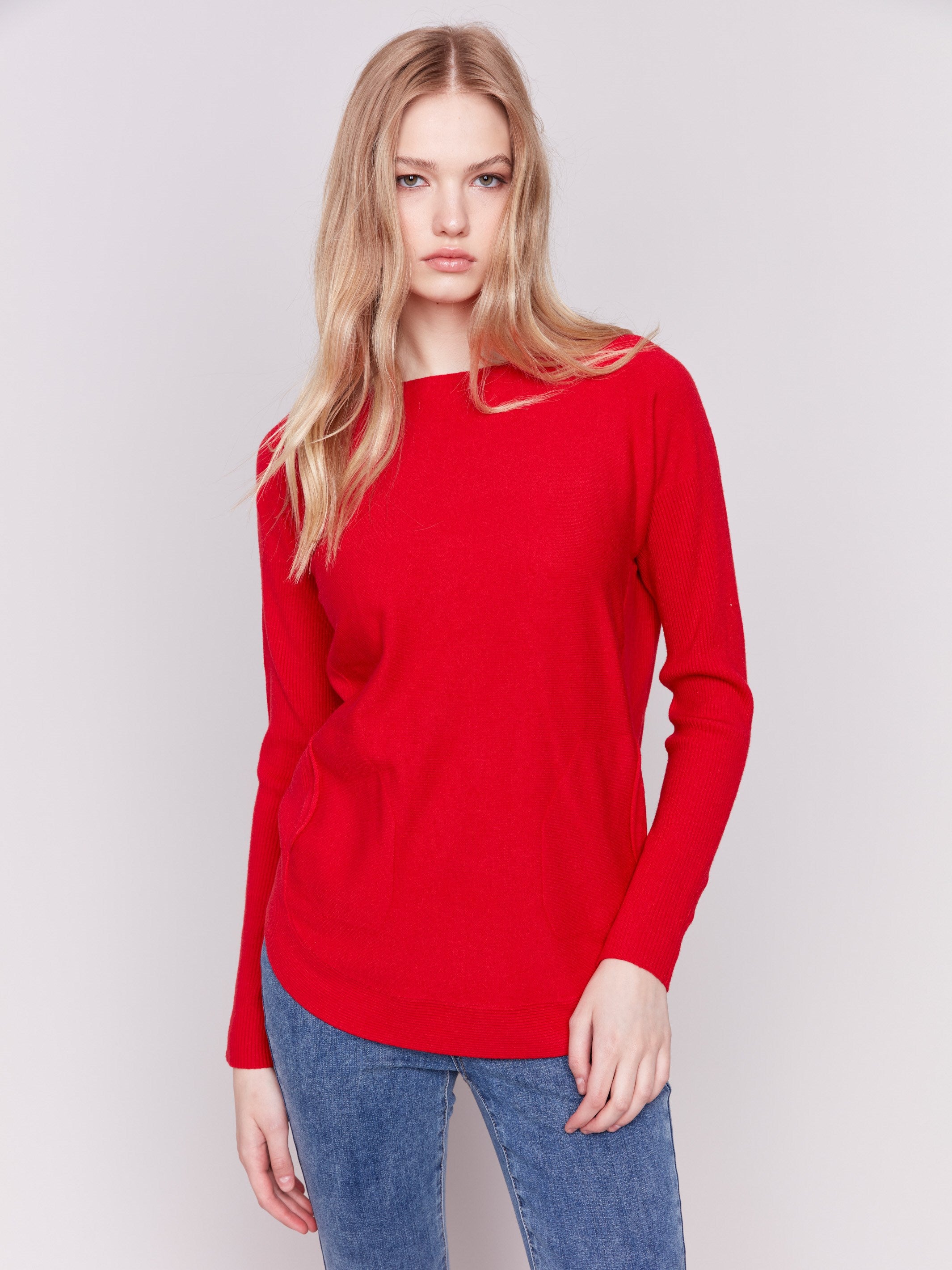 Cranberry red long-sleeved knit sweater with lace-up cuffs, rounded hem, and front pockets by Charlie B.