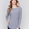 Grey long-sleeved knit sweater with lace-up cuffs, rounded hem, and front pockets by Charlie B.