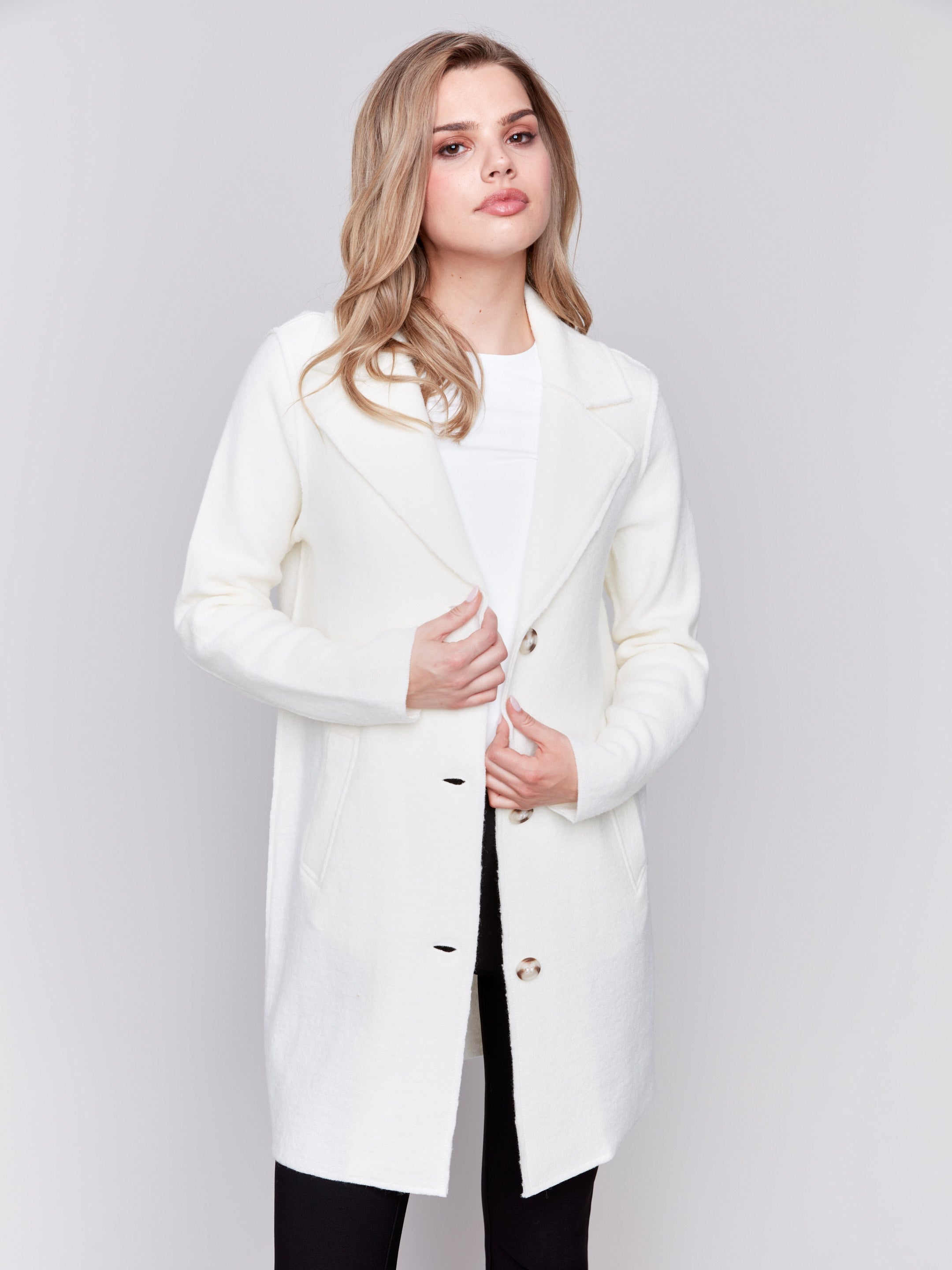 Ecru long wool coat with lapel notch collar and button closures, featuring front welt pockets by Charlie B.