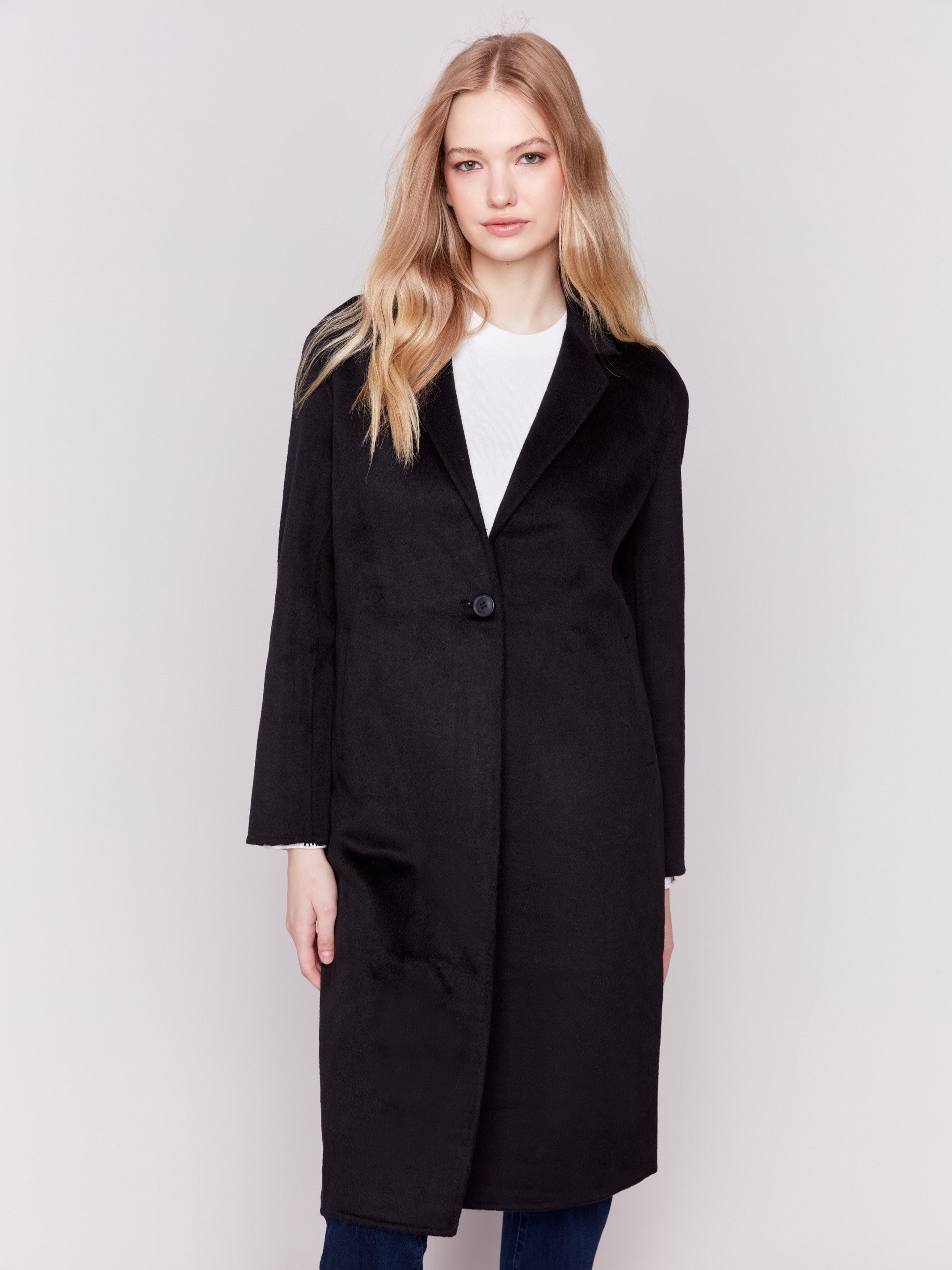 Black long double-faced wool coat with a minimalist design, single-breasted front, and sleek button closure by Charlie B.