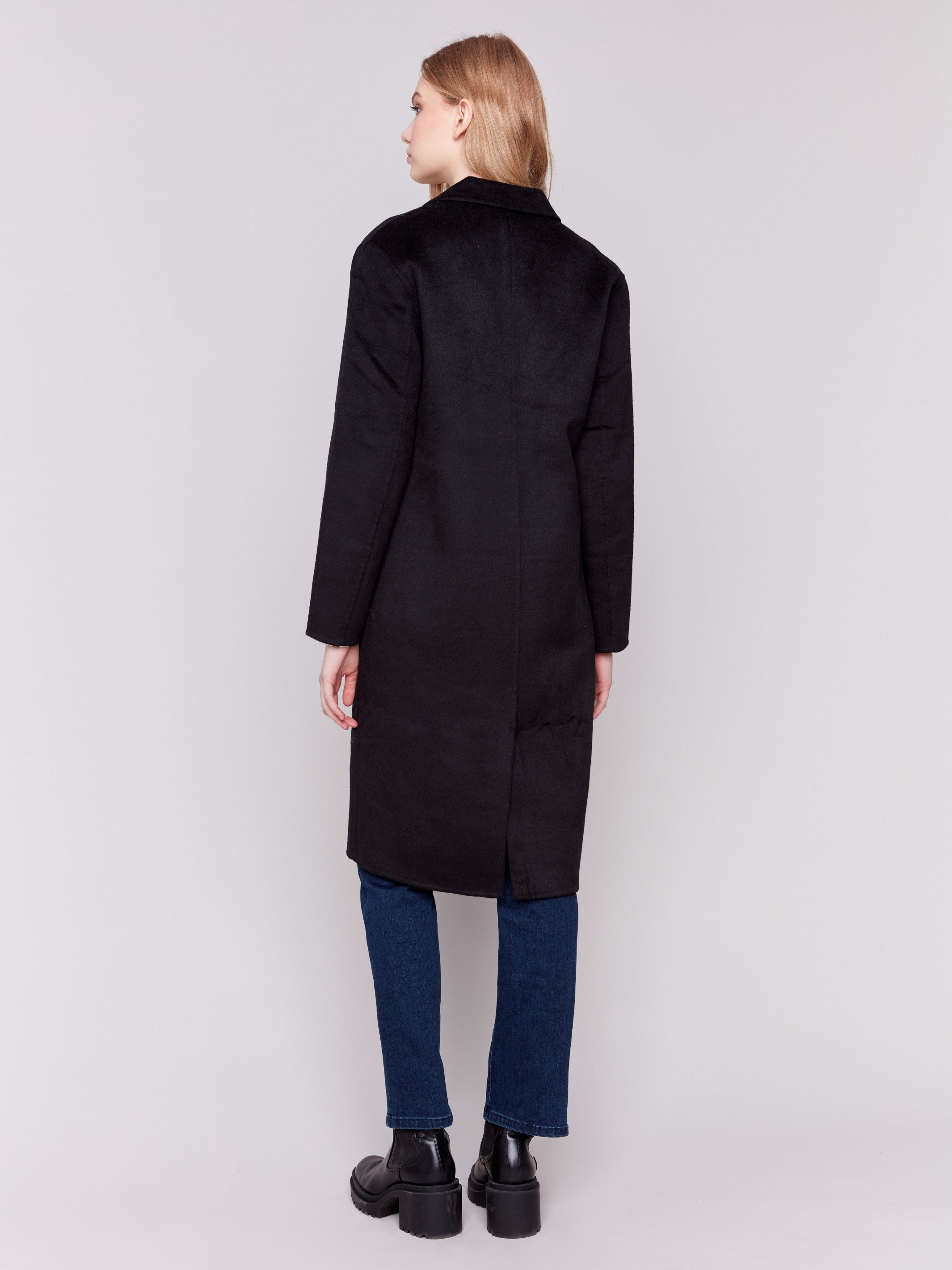 Black long double-faced wool coat with a minimalist design, single-breasted front, and sleek button closure by Charlie B.