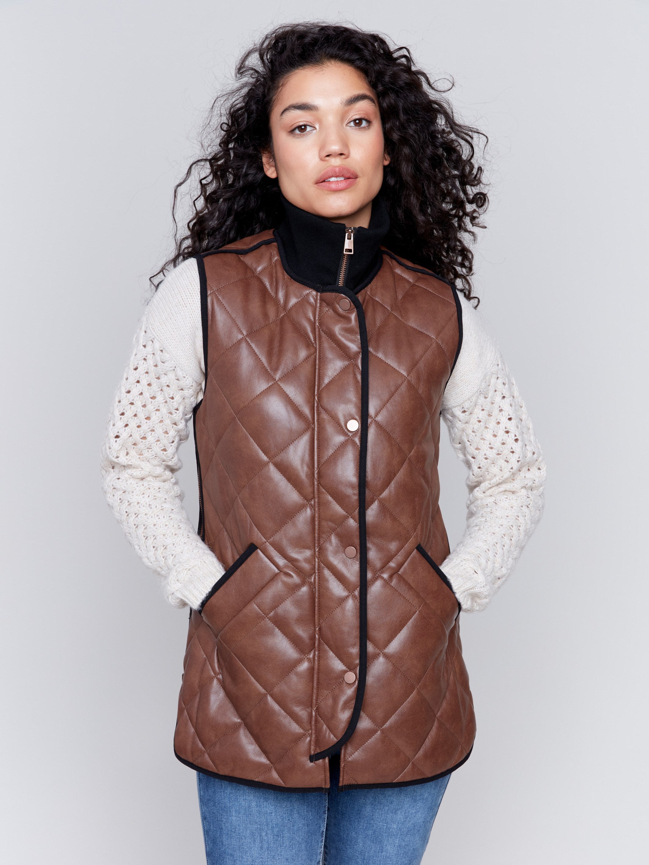 Brown faux leather vest with quilted design, featuring a front zipper closure and side welt pockets, by Charlie B.