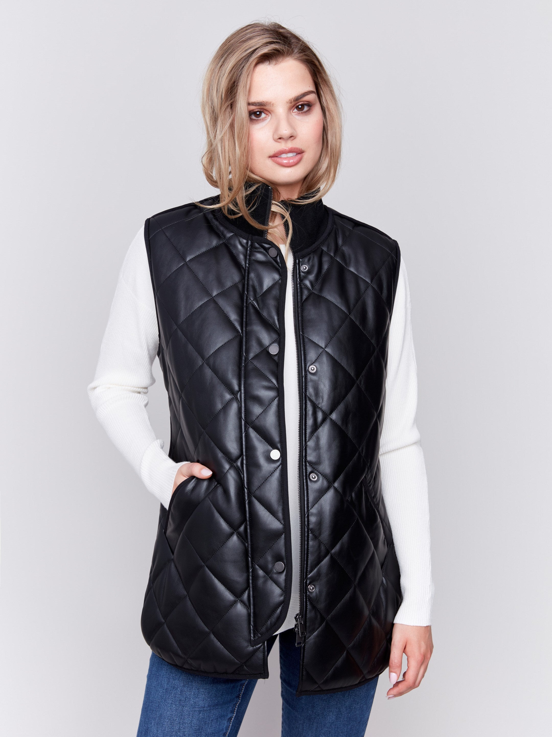 Black faux leather vest with quilted design, featuring a front zipper closure and side welt pockets, by Charlie B.