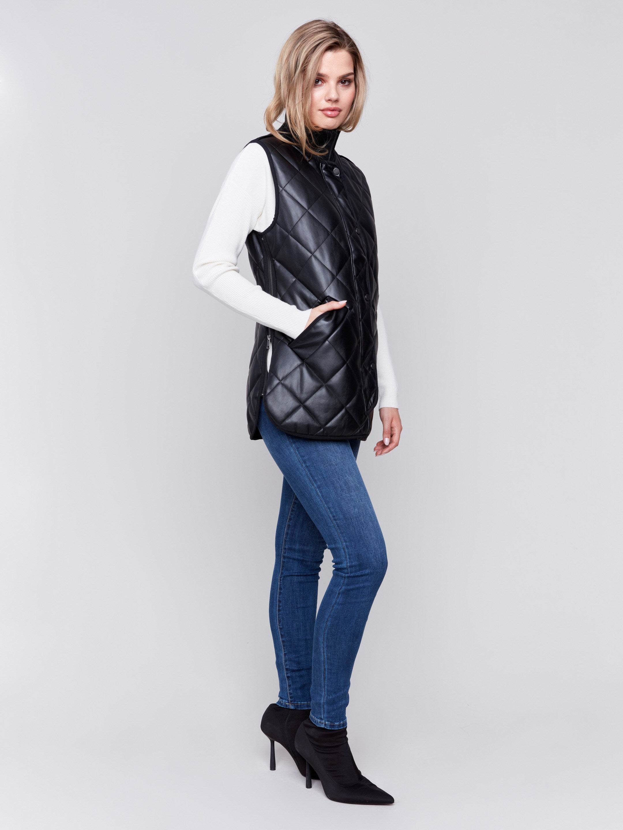 Black faux leather vest with quilted design, featuring a front zipper closure and side welt pockets, by Charlie B.