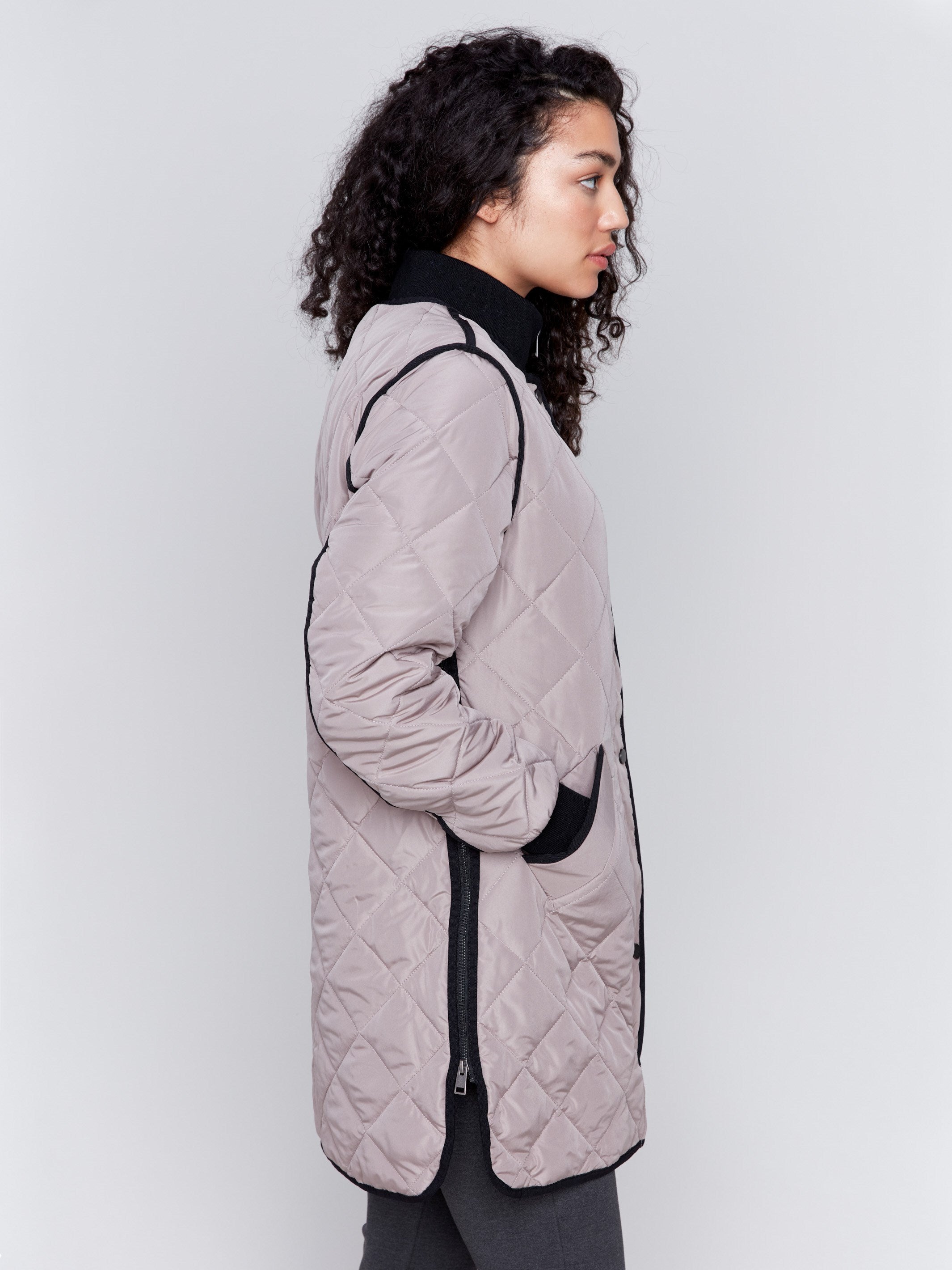 Taupe long quilted puffer jacket with rib knit detail, zipper front, and front pockets by Charlie B.