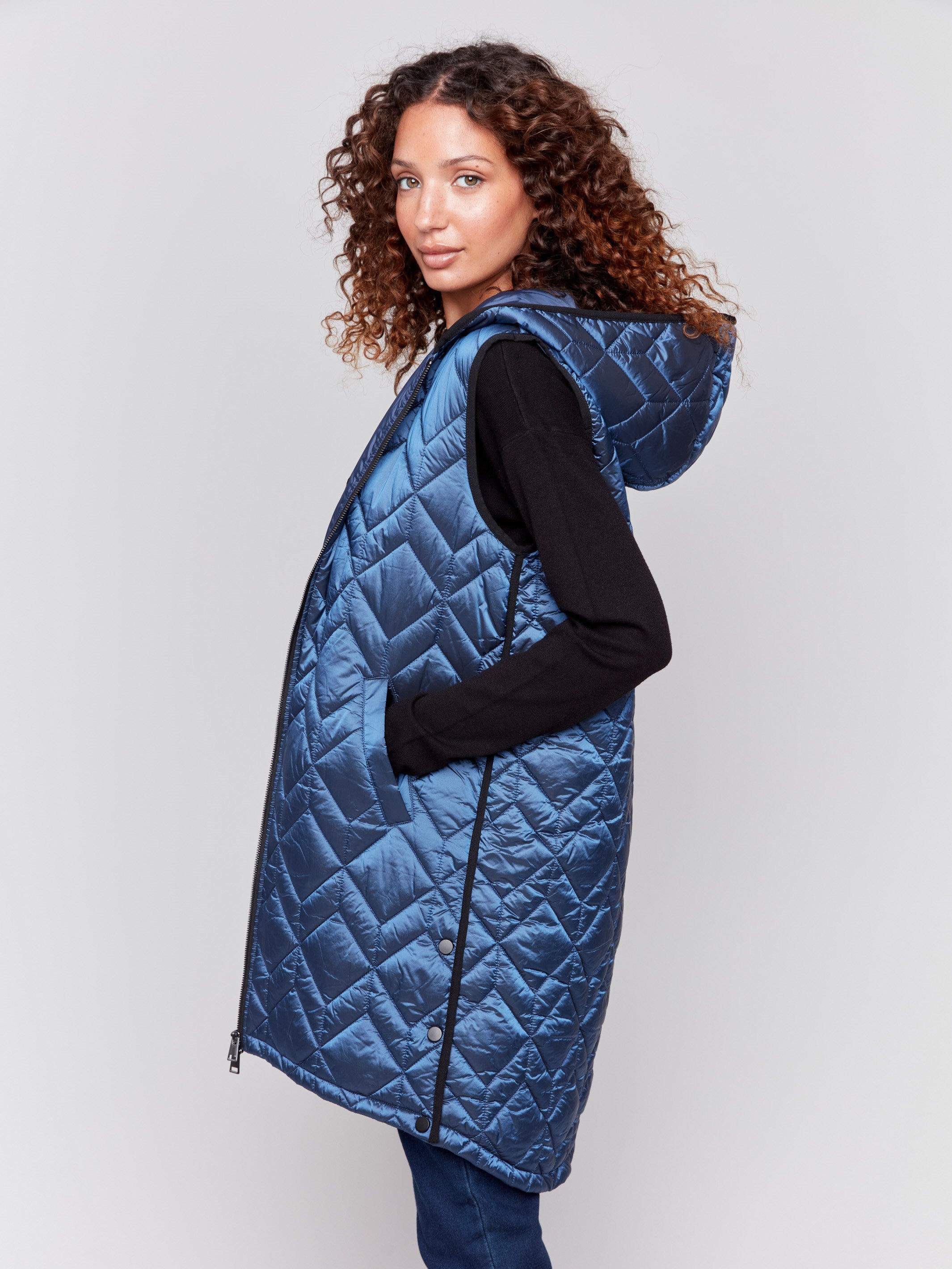 Navy blue long quilted puffer vest with hood and a zippered front by Charlie B.