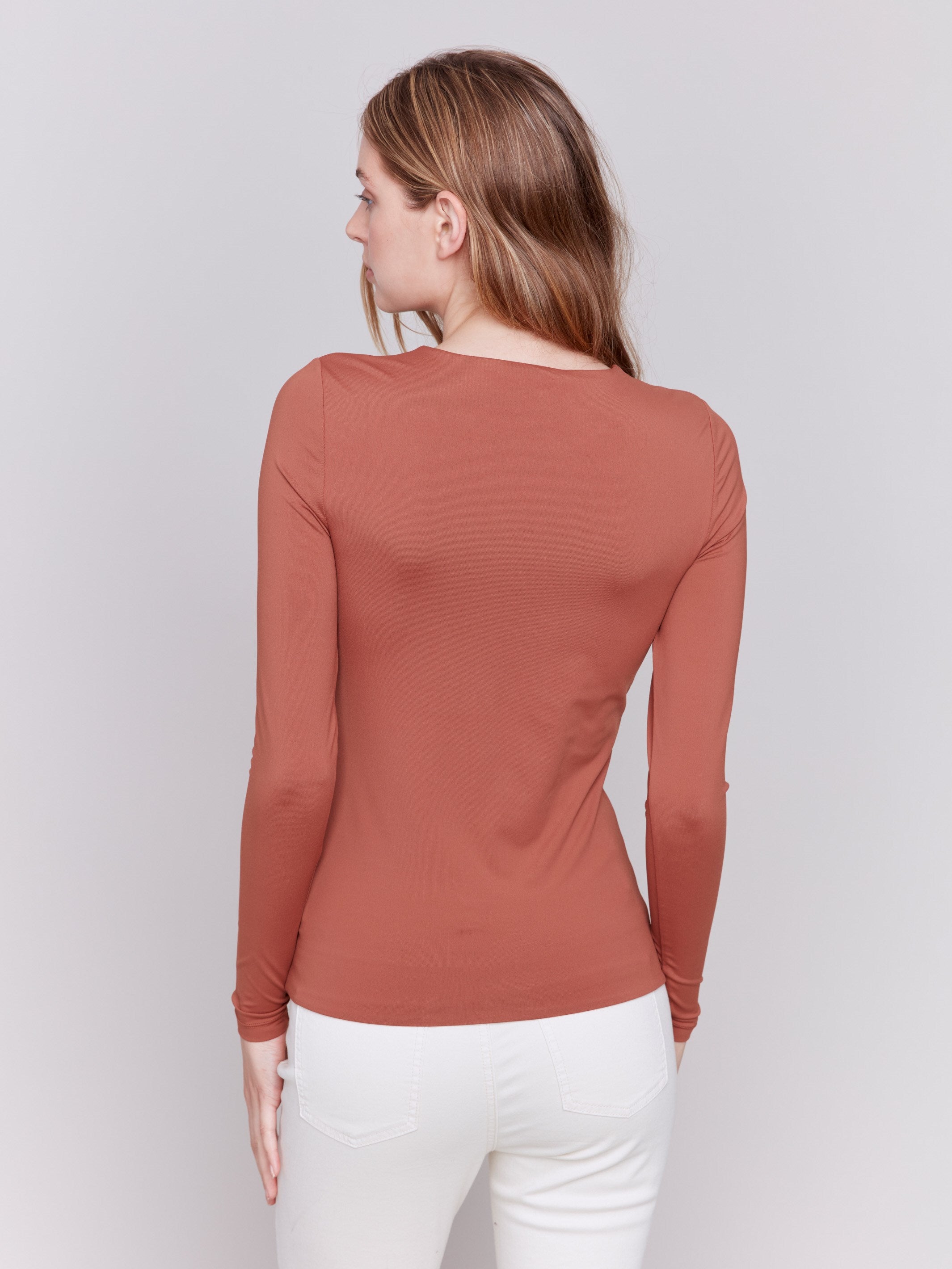 Terracotta long-sleeve top with crew neckline, featuring a fitted silhouette by Charlie B.