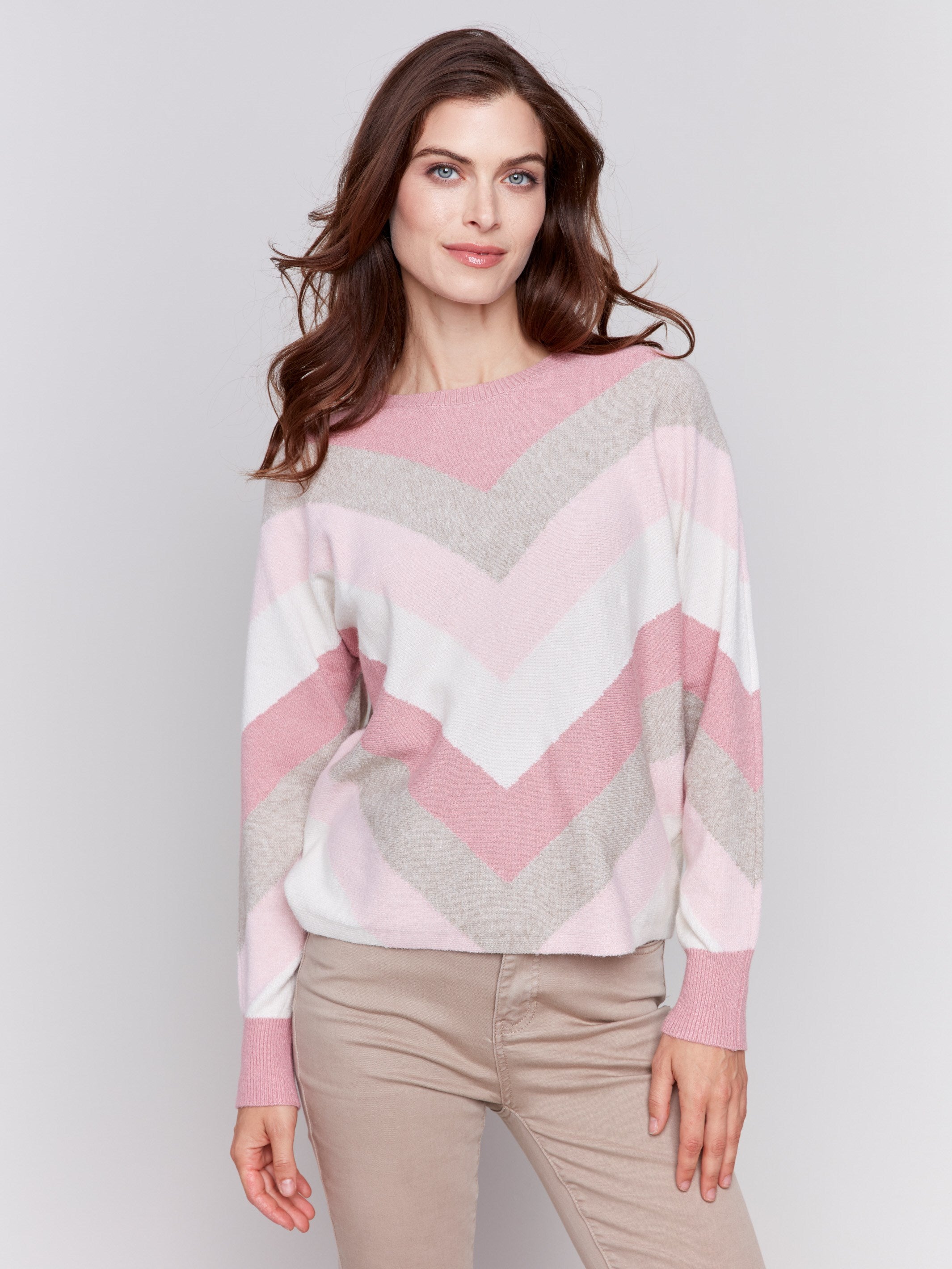 Woodrose-colored long-sleeve sweater with chevron stripes in pink, white, and beige. Crew neckline and ribbed cuffs by Charlie B.