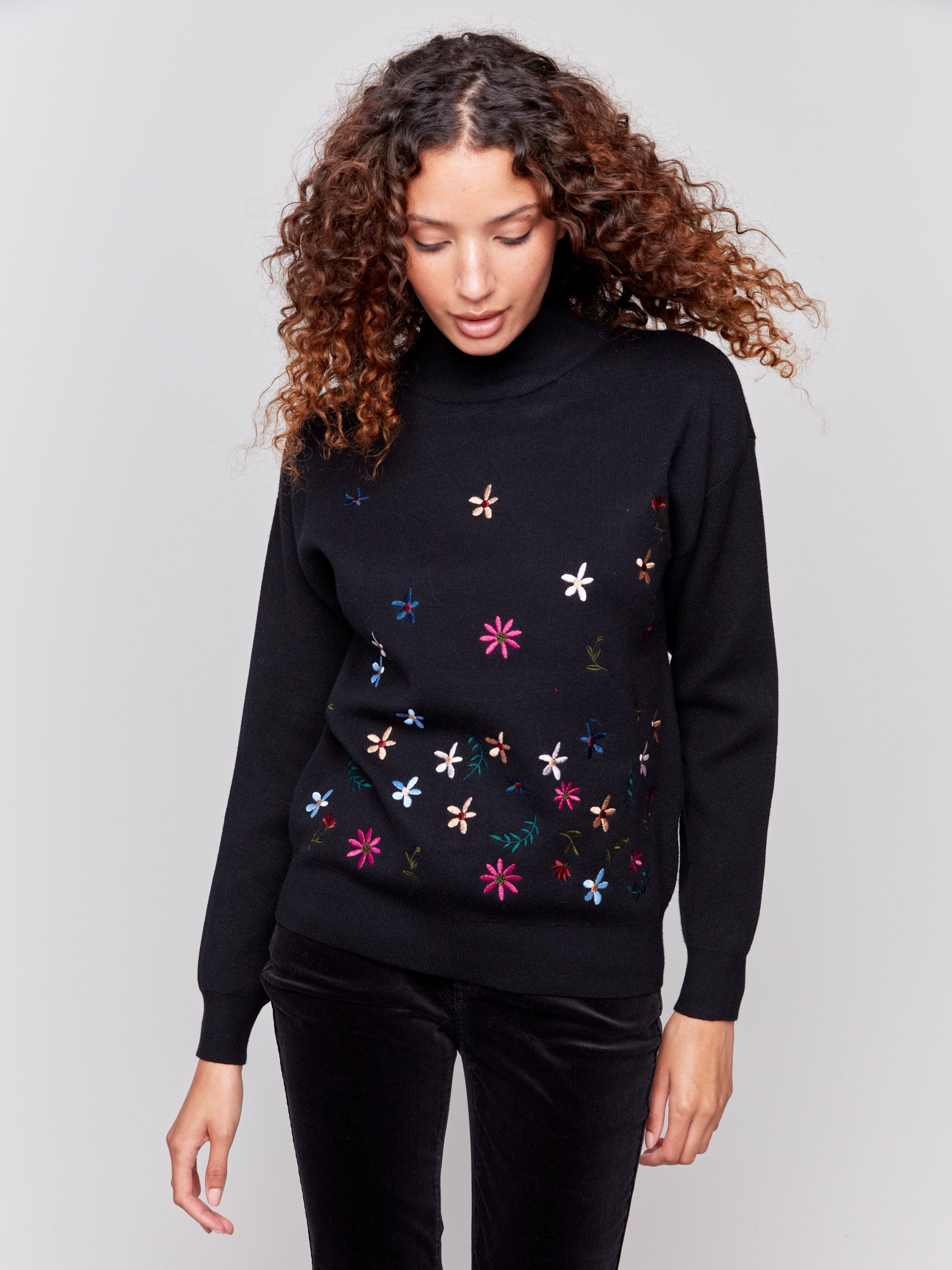 Black long-sleeve mock neck sweater with colorful floral embroidery by Charlie B.