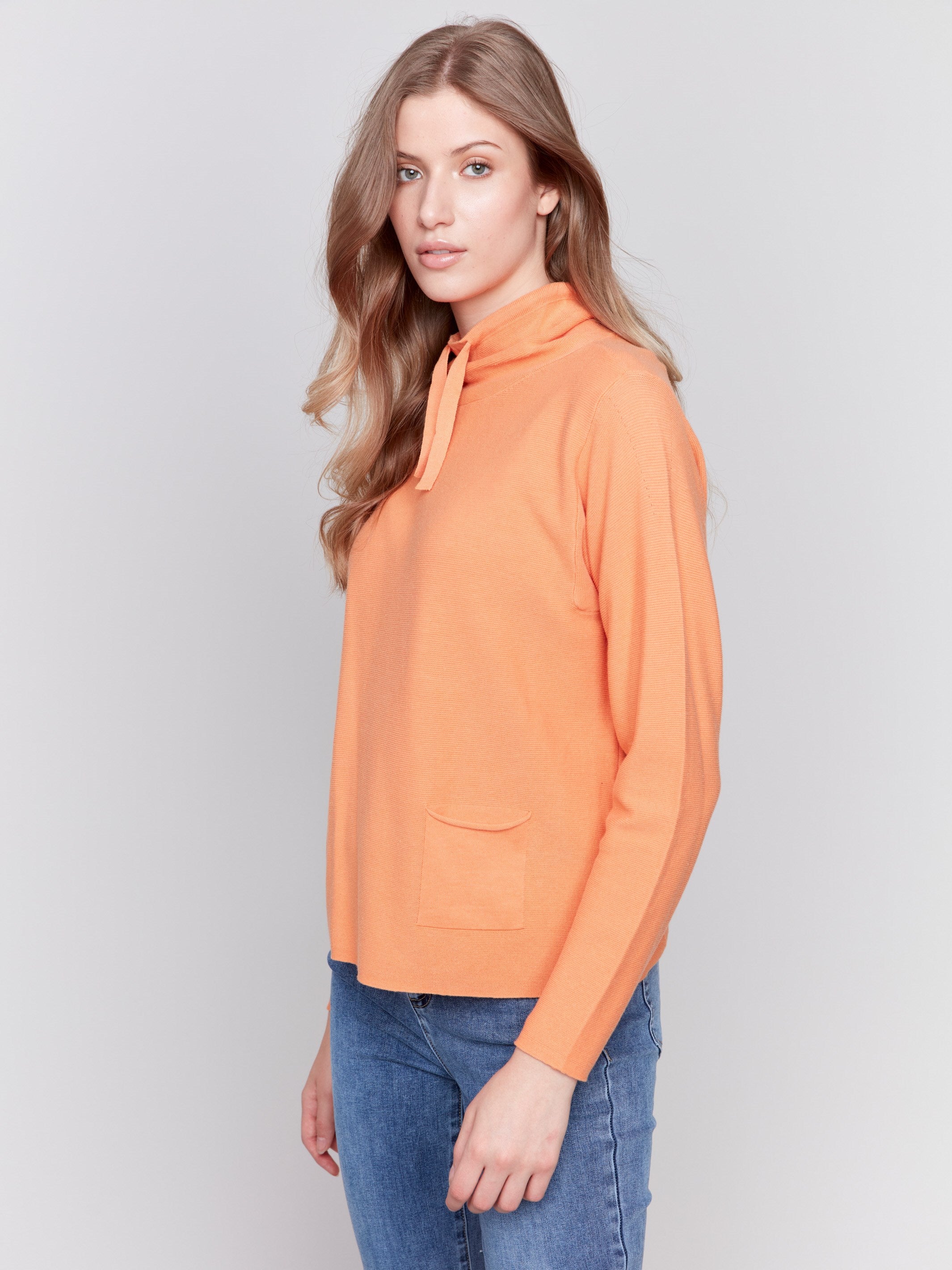 Orange ottoman cotton funnel neck sweater with a small front pocket, featuring long sleeves and a cozy style by Charlie B.