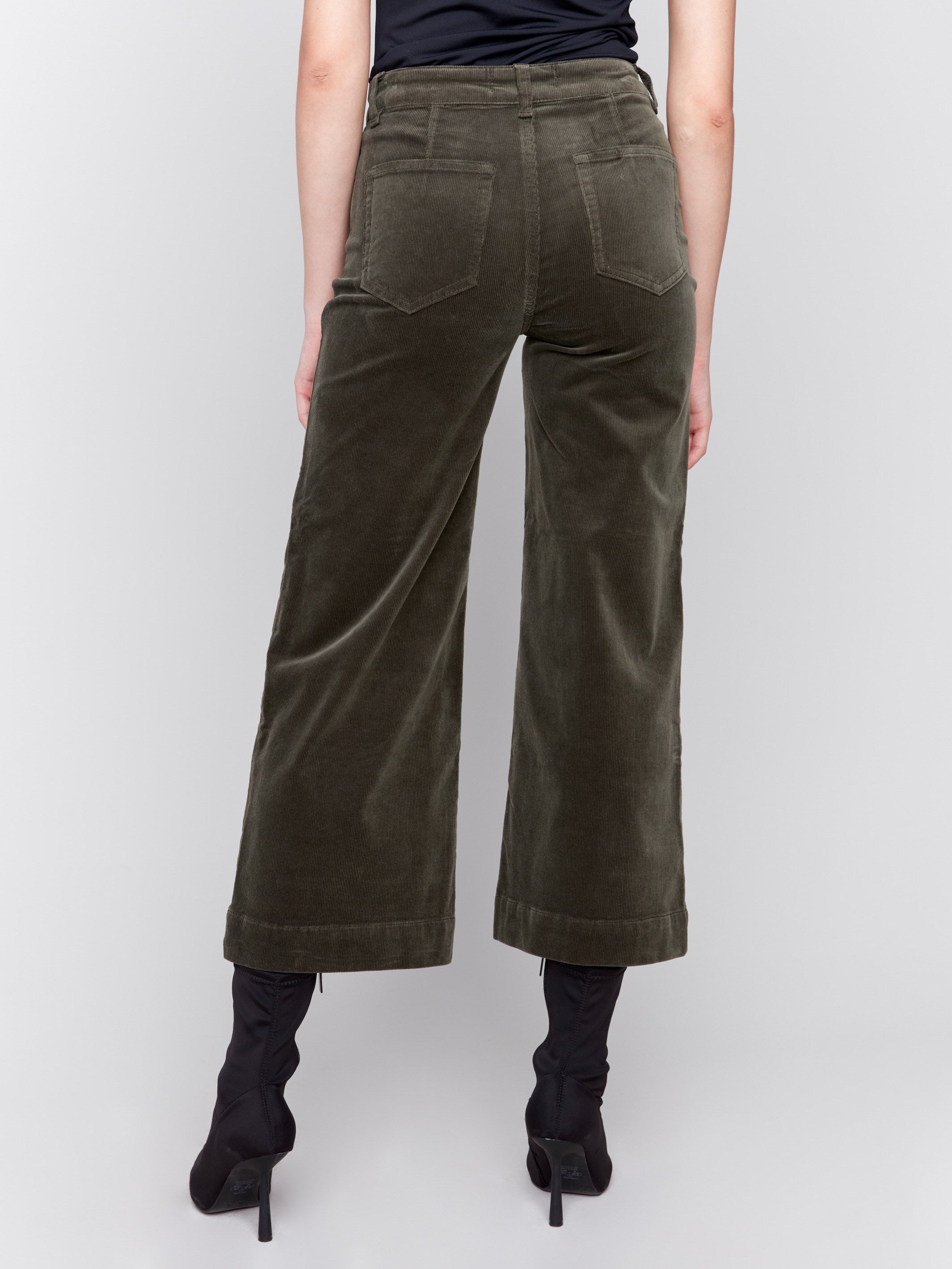 Green corduroy flare pants with front and back patch pockets, a regular rise, and cropped design by Charlie B.