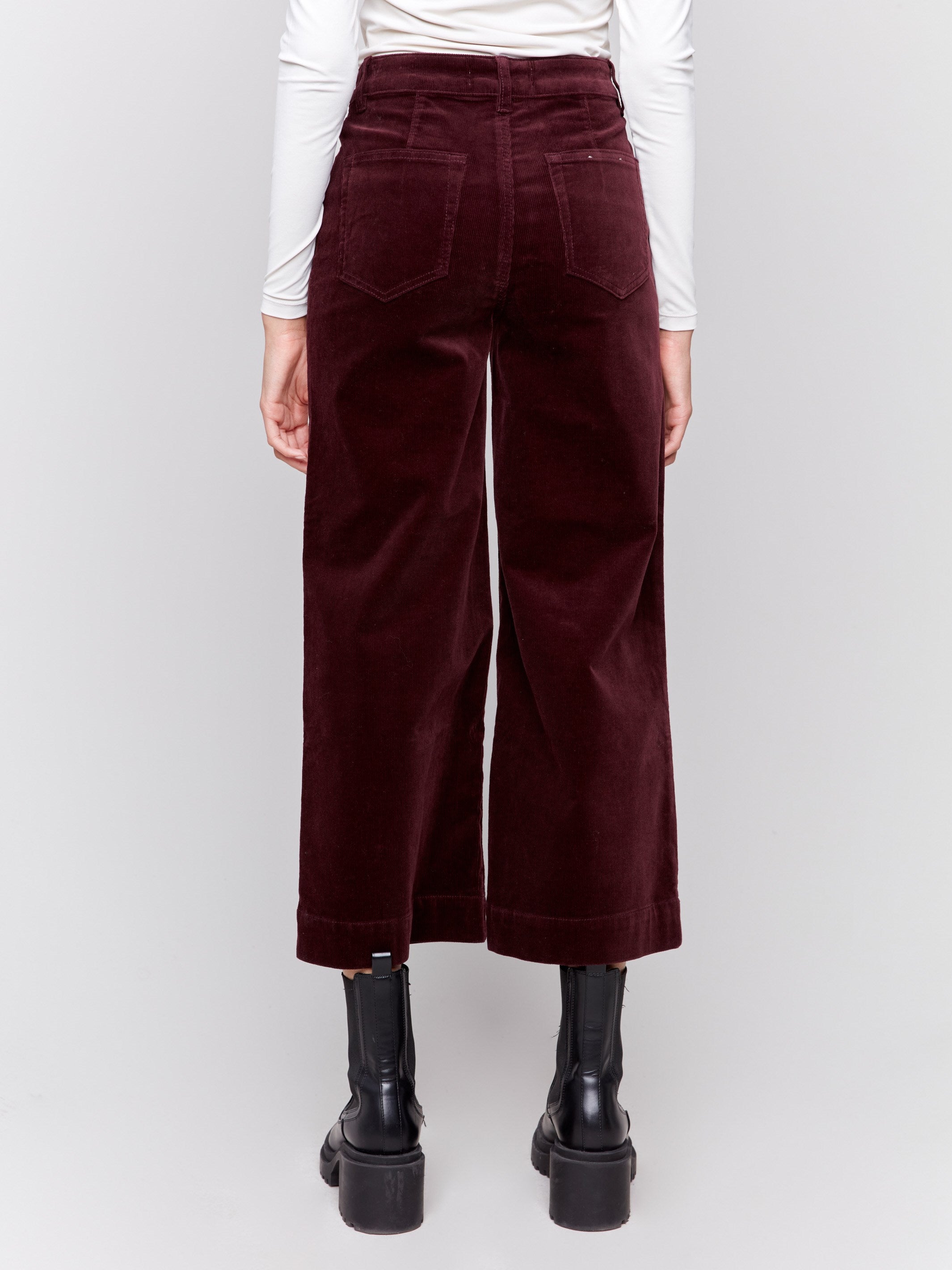 Plum purple corduroy flare pants with front and back patch pockets, a regular rise, and cropped design by Charlie B.