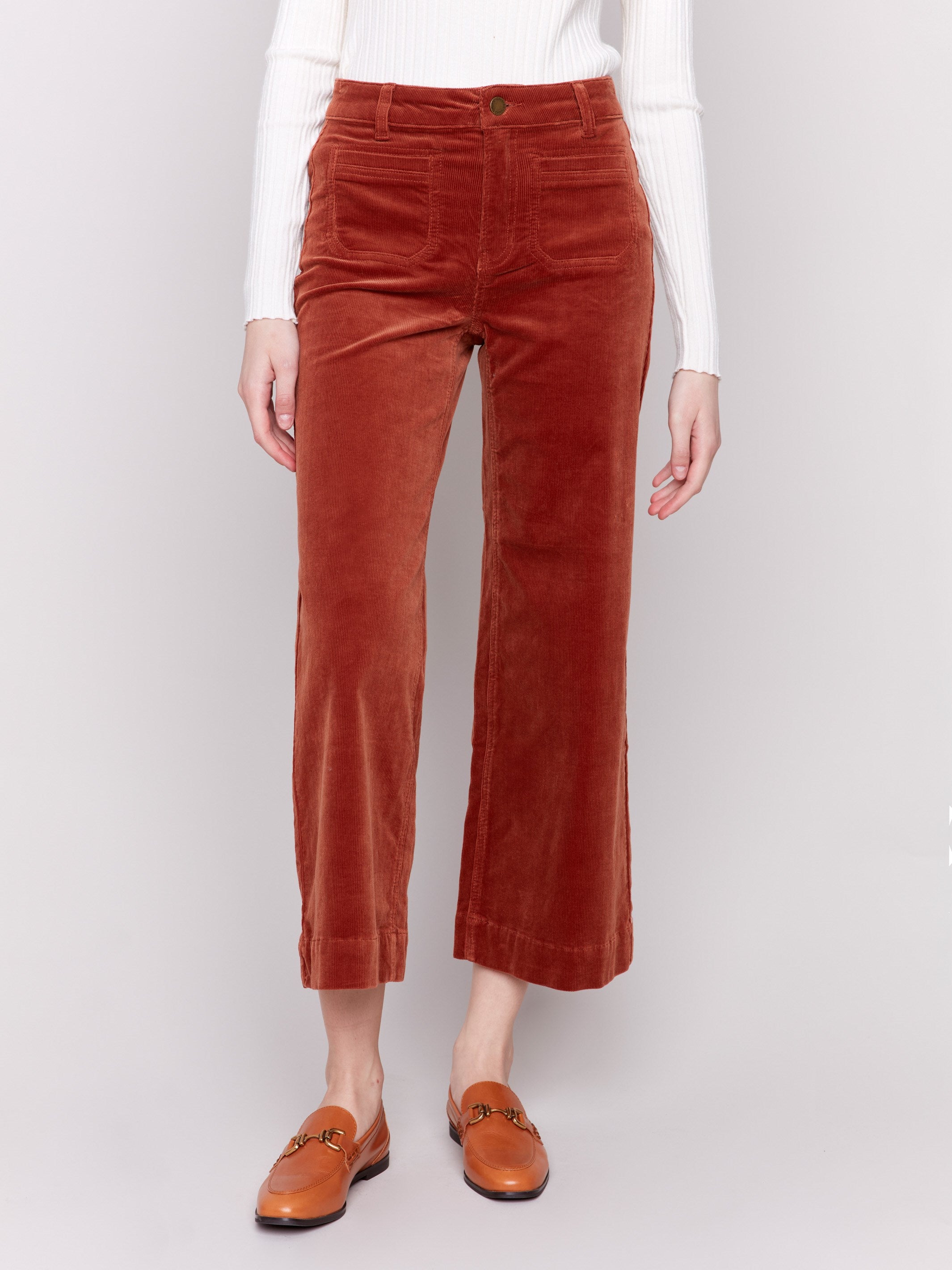 Terracotta orange corduroy flare pants with front and back patch pockets, a regular rise, and cropped design by Charlie B.