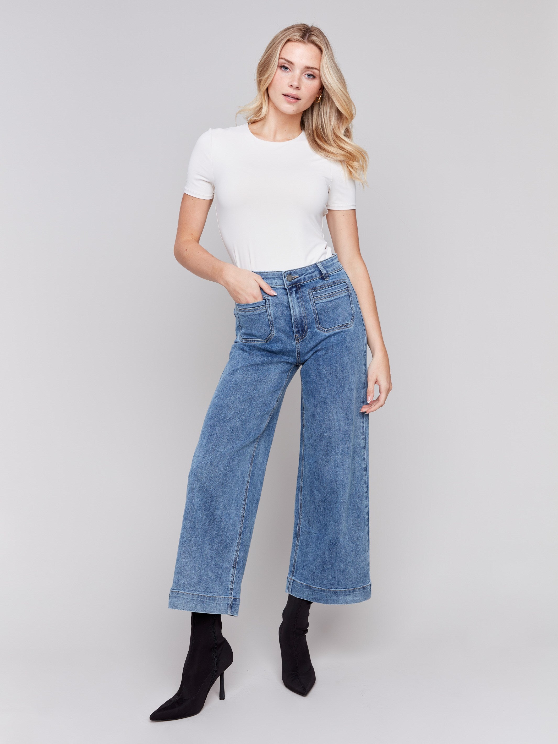 Medium blue jeans with front patch pockets and a flared leg, featuring a mid-rise by Charlie B.