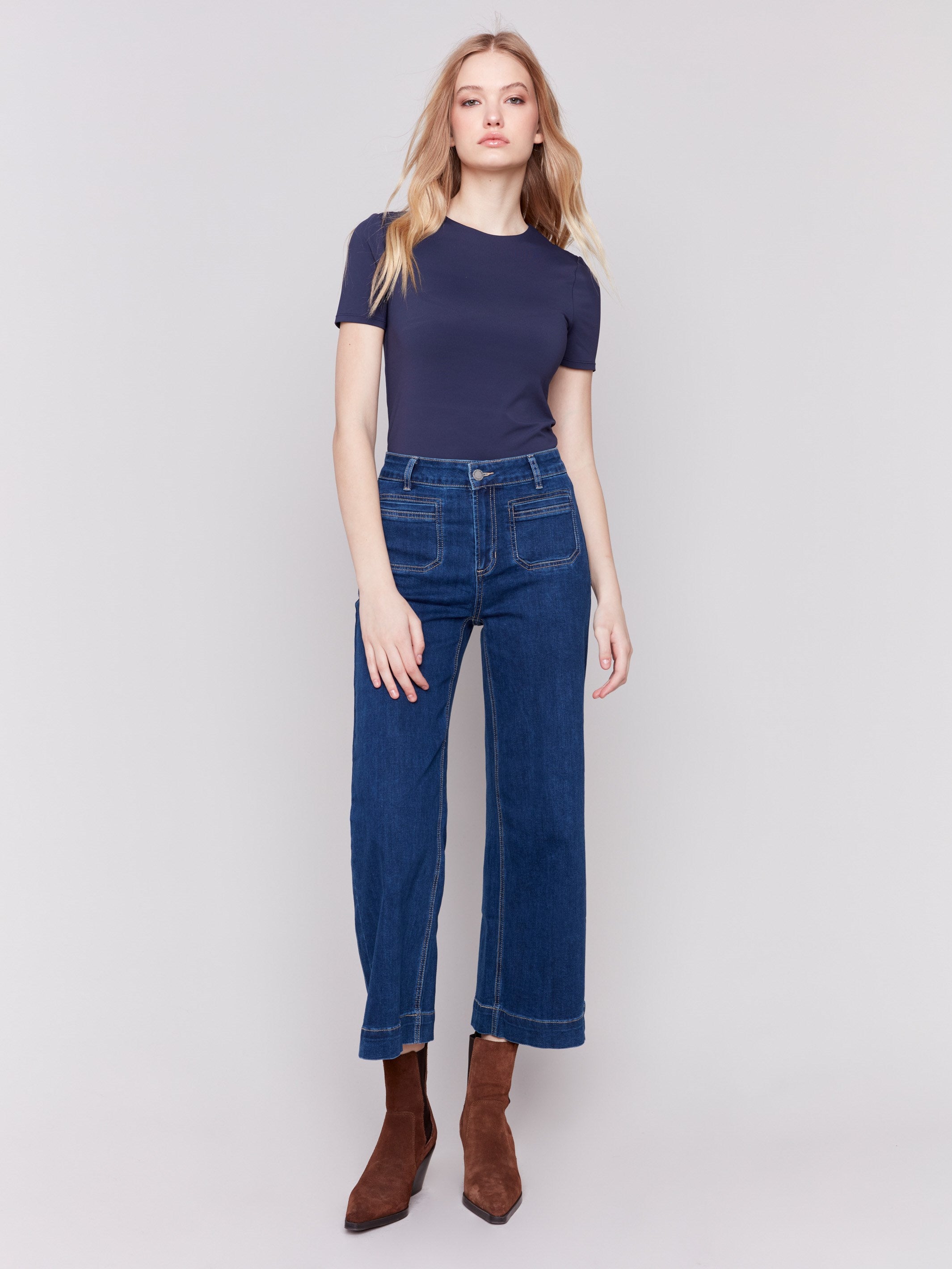 Indigo blue jeans with front patch pockets and a flared leg, featuring a mid-rise by Charlie B.