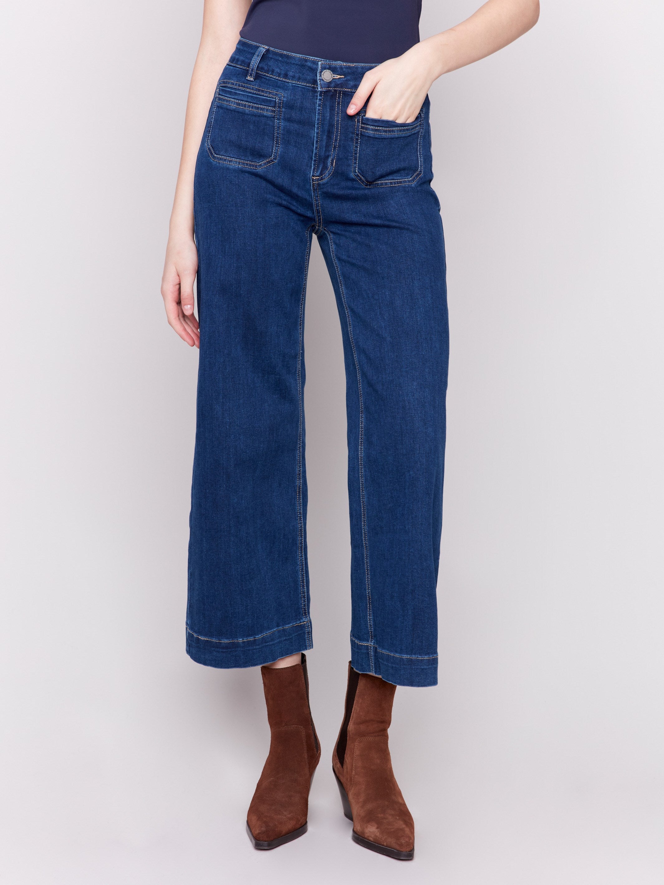 Indigo blue jeans with front patch pockets and a flared leg, featuring a mid-rise by Charlie B.