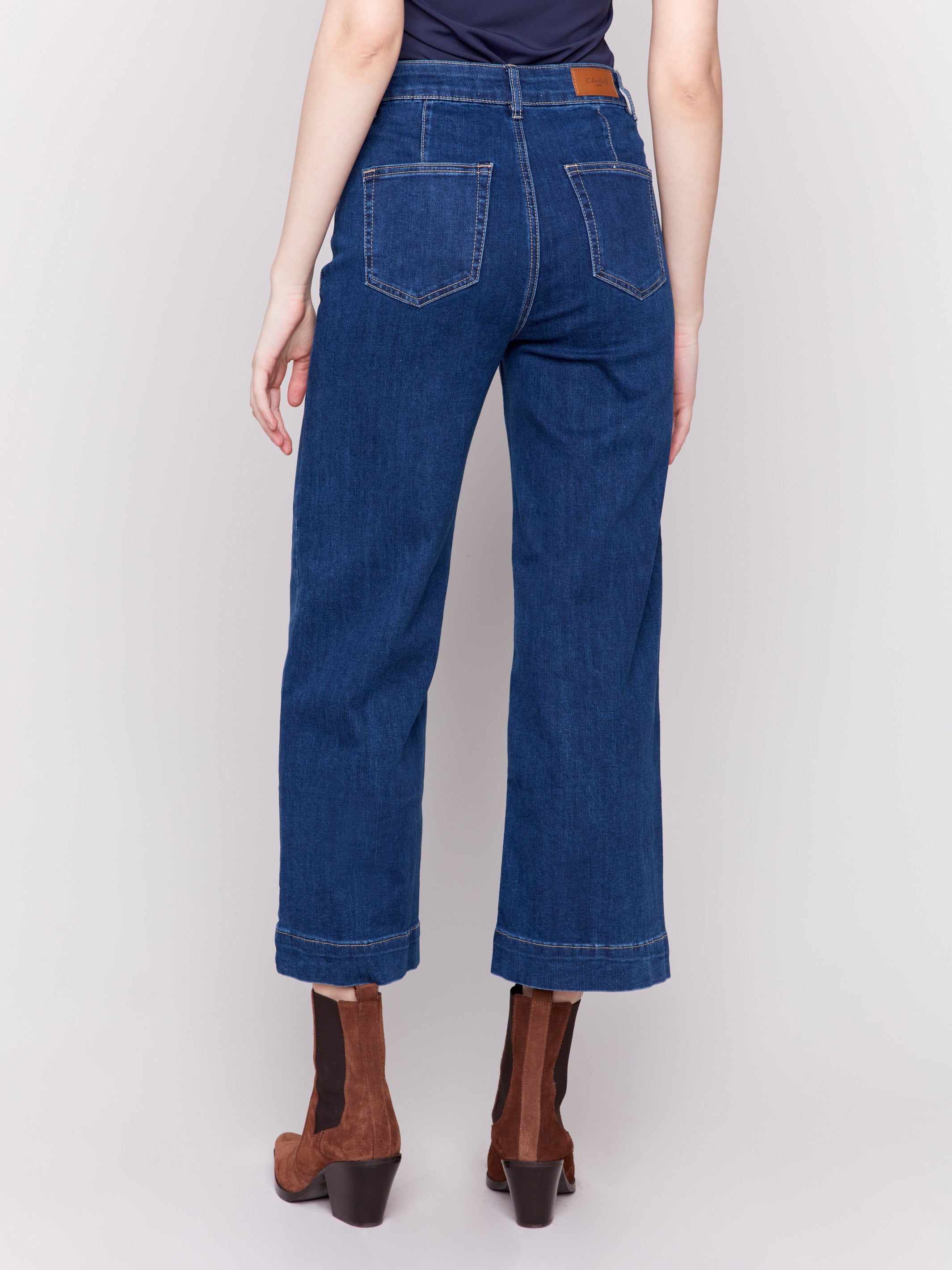 Indigo blue jeans with front patch pockets and a flared leg, featuring a mid-rise by Charlie B.