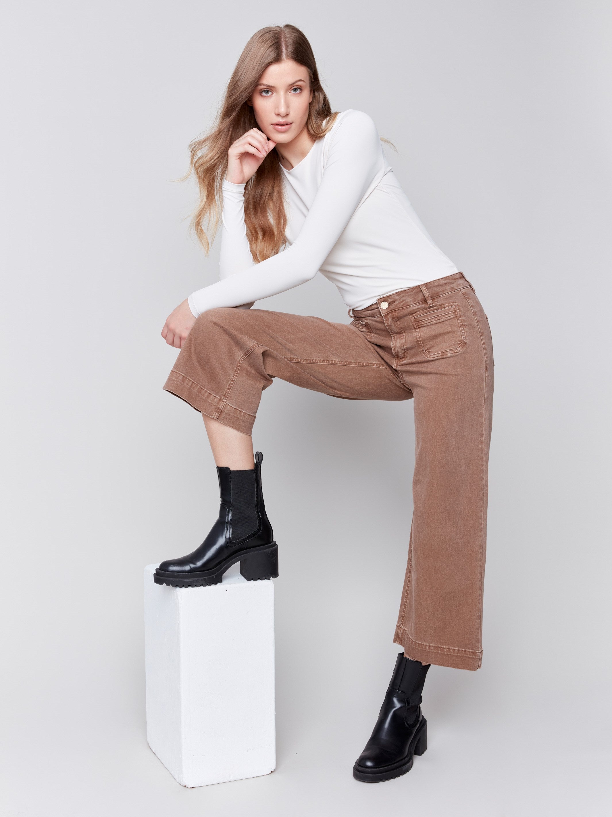 Brown cropped twill pants with front patch pockets and a flare leg by Charlie B.