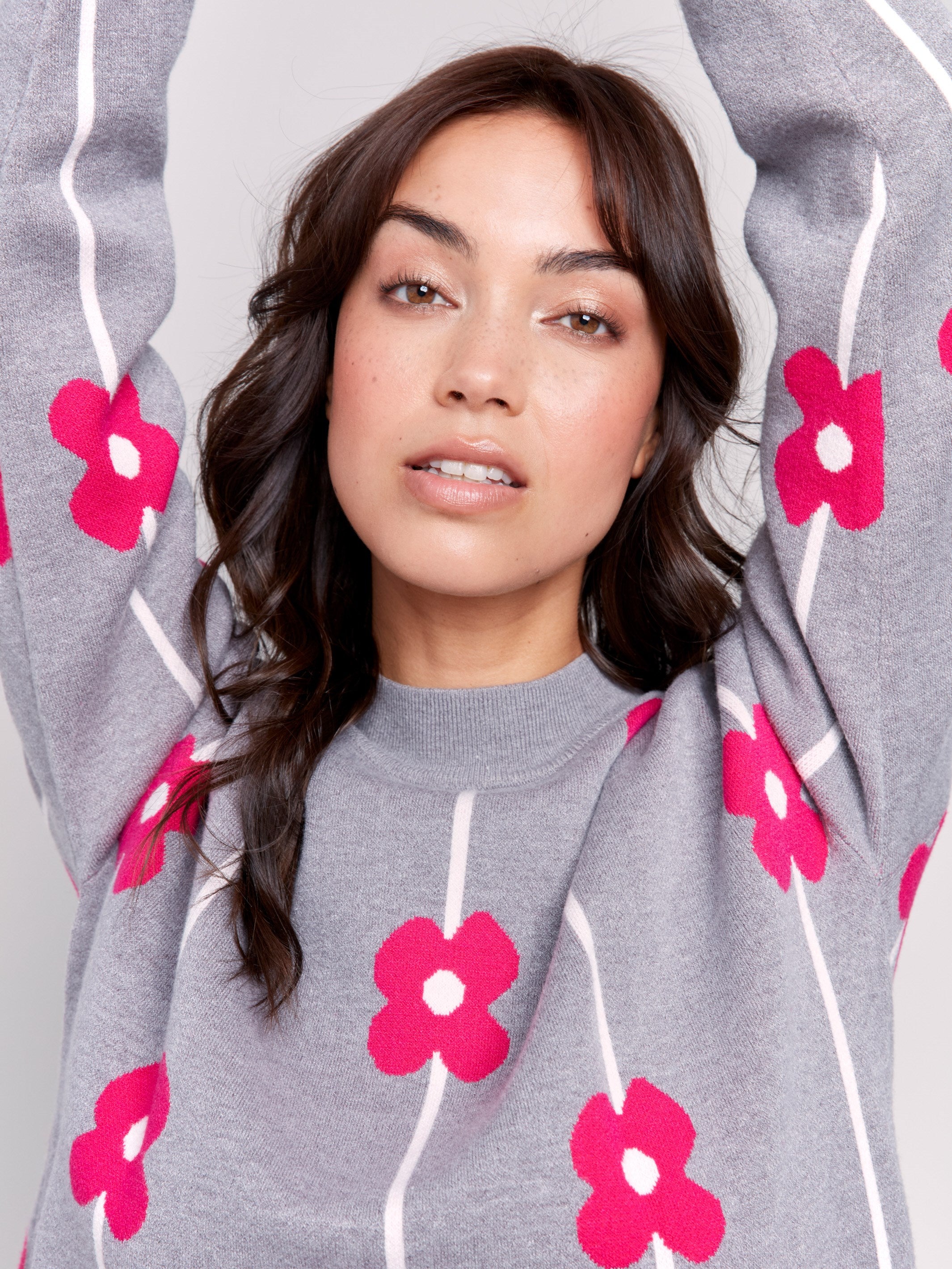 Heather grey sweater with pink floral print and a round neckline by Charlie B.