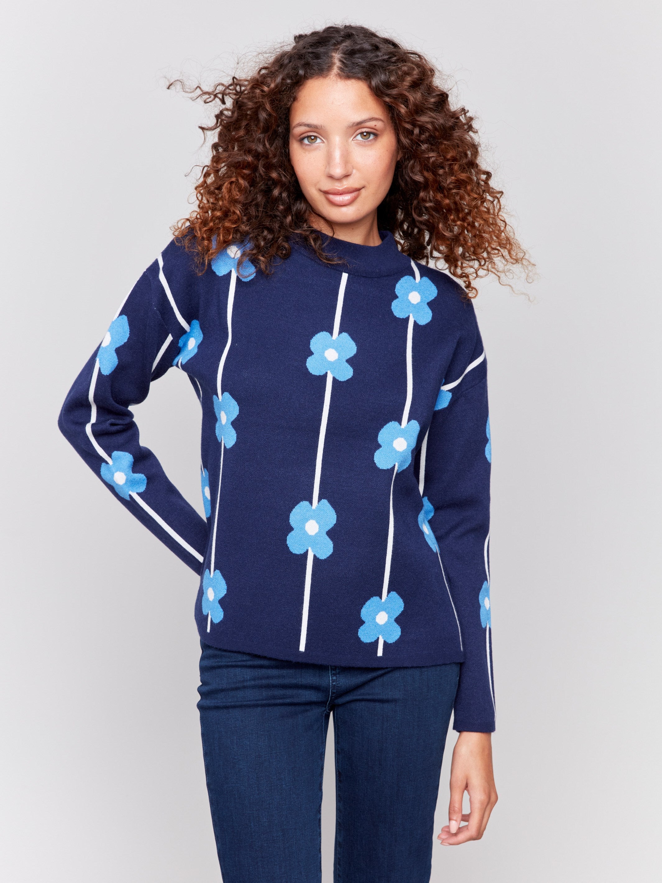 Navy sweater with blue floral print and a round neckline by Charlie B.