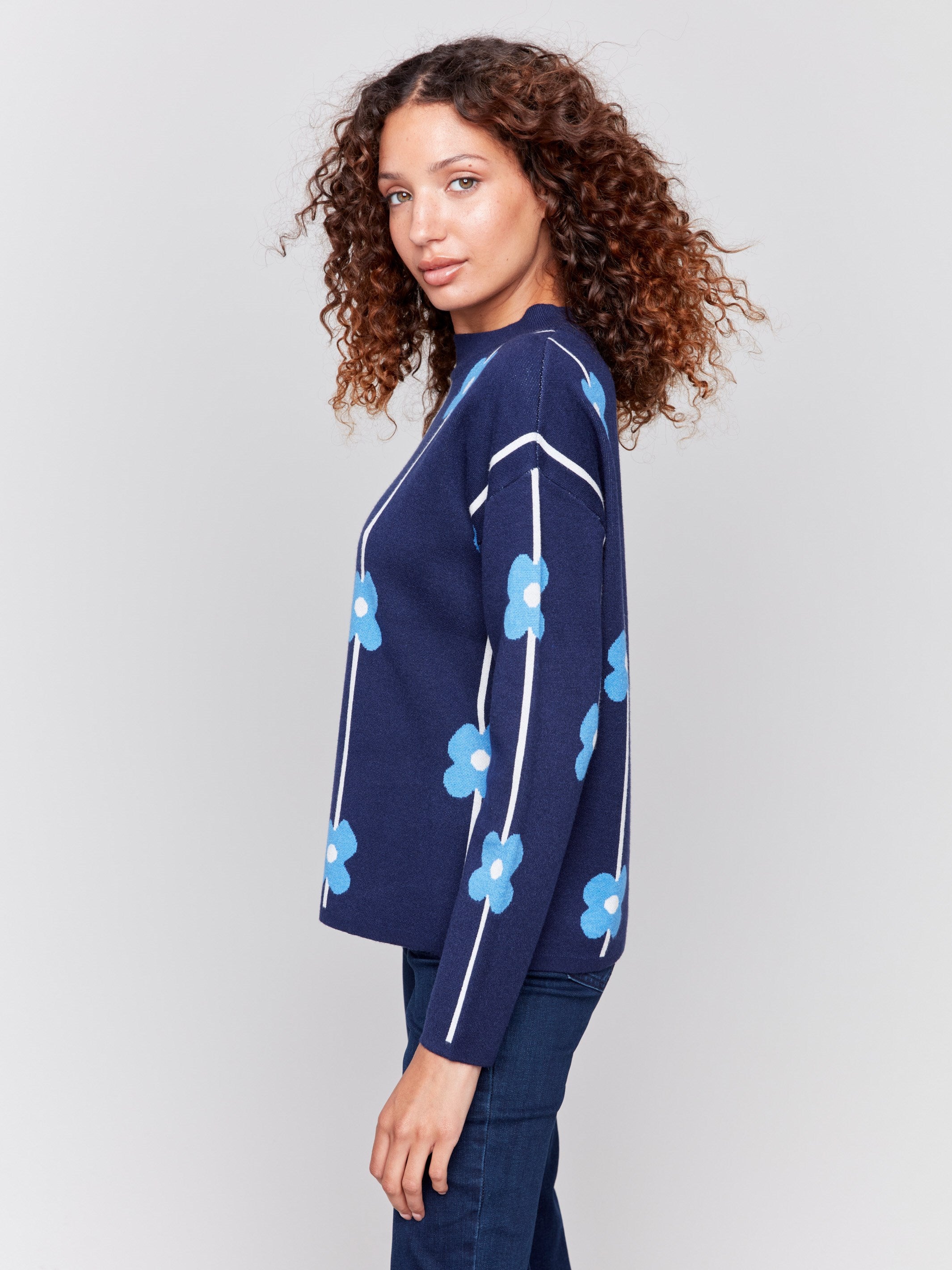 Navy sweater with blue floral print and a round neckline by Charlie B.