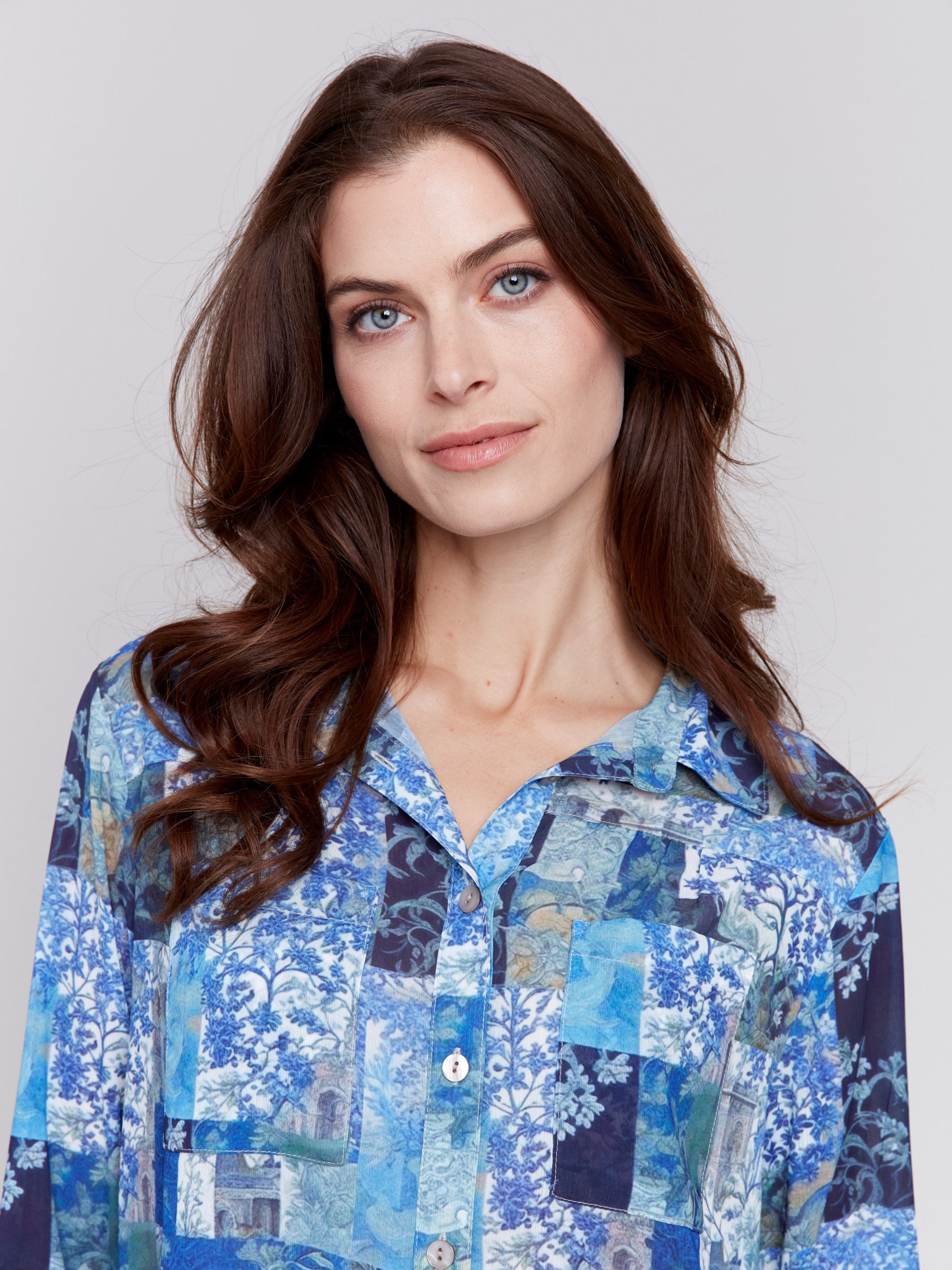 Blue printed blouse with button-front, featuring patch pockets and roll-up sleeves by Charlie B