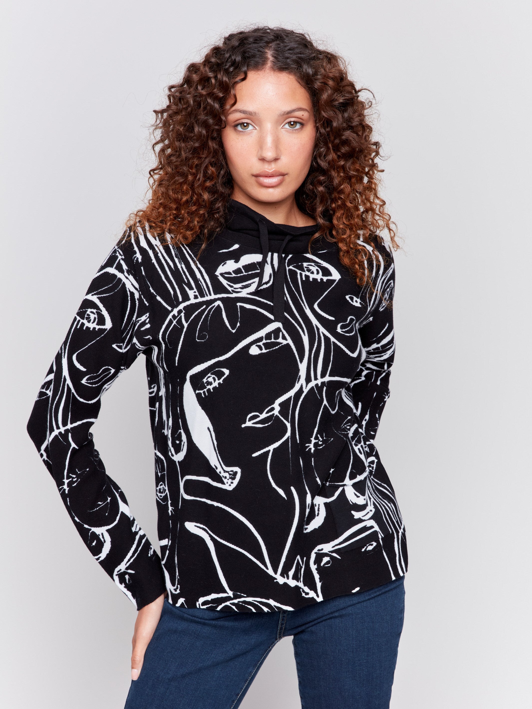 Black and white abstract face print funnel neck cotton sweater for women by Charlie B.