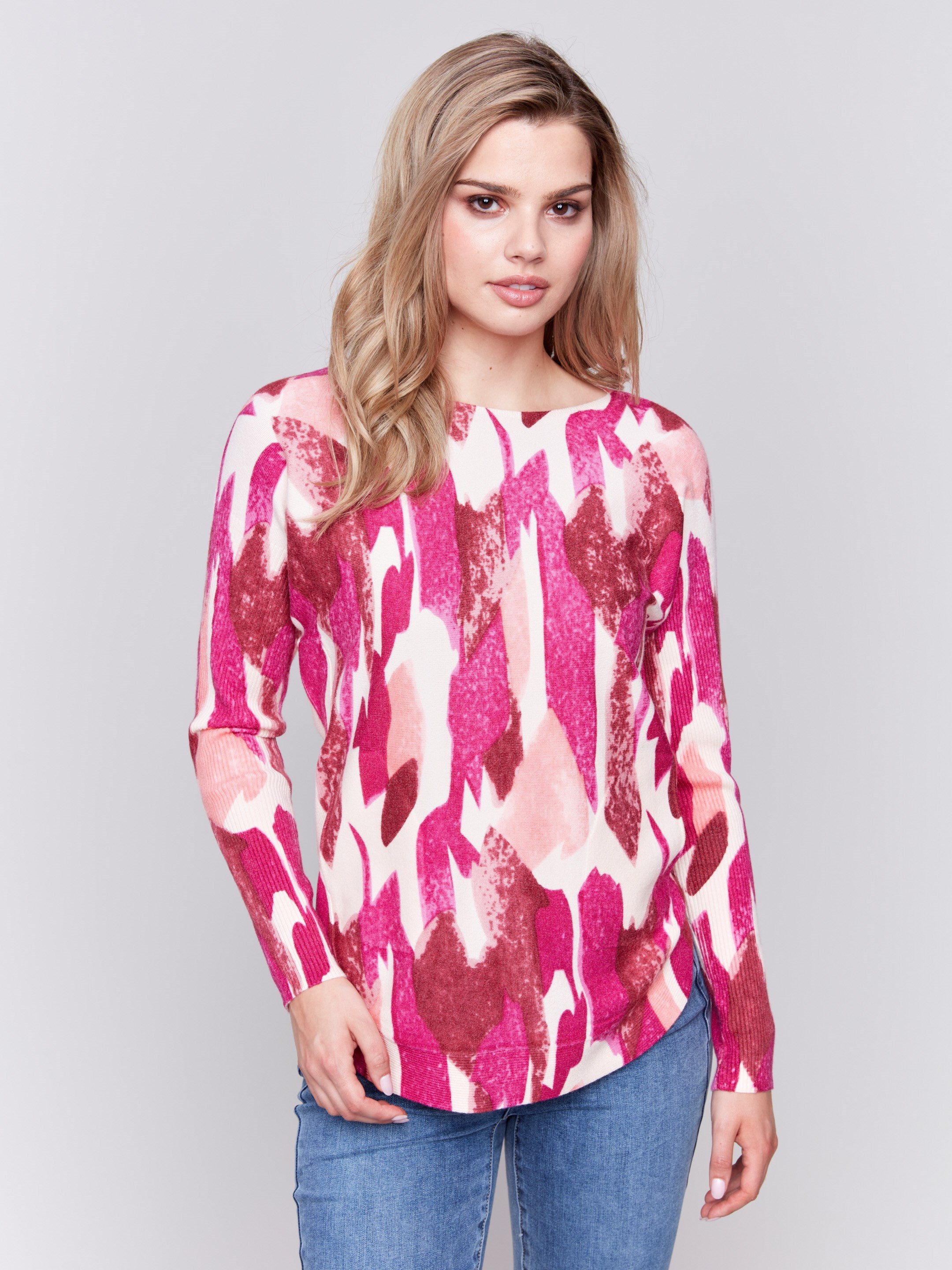 Fuchsia pink abstract print plush knit sweater with rounded hem and hidden pockets by Charlie B.