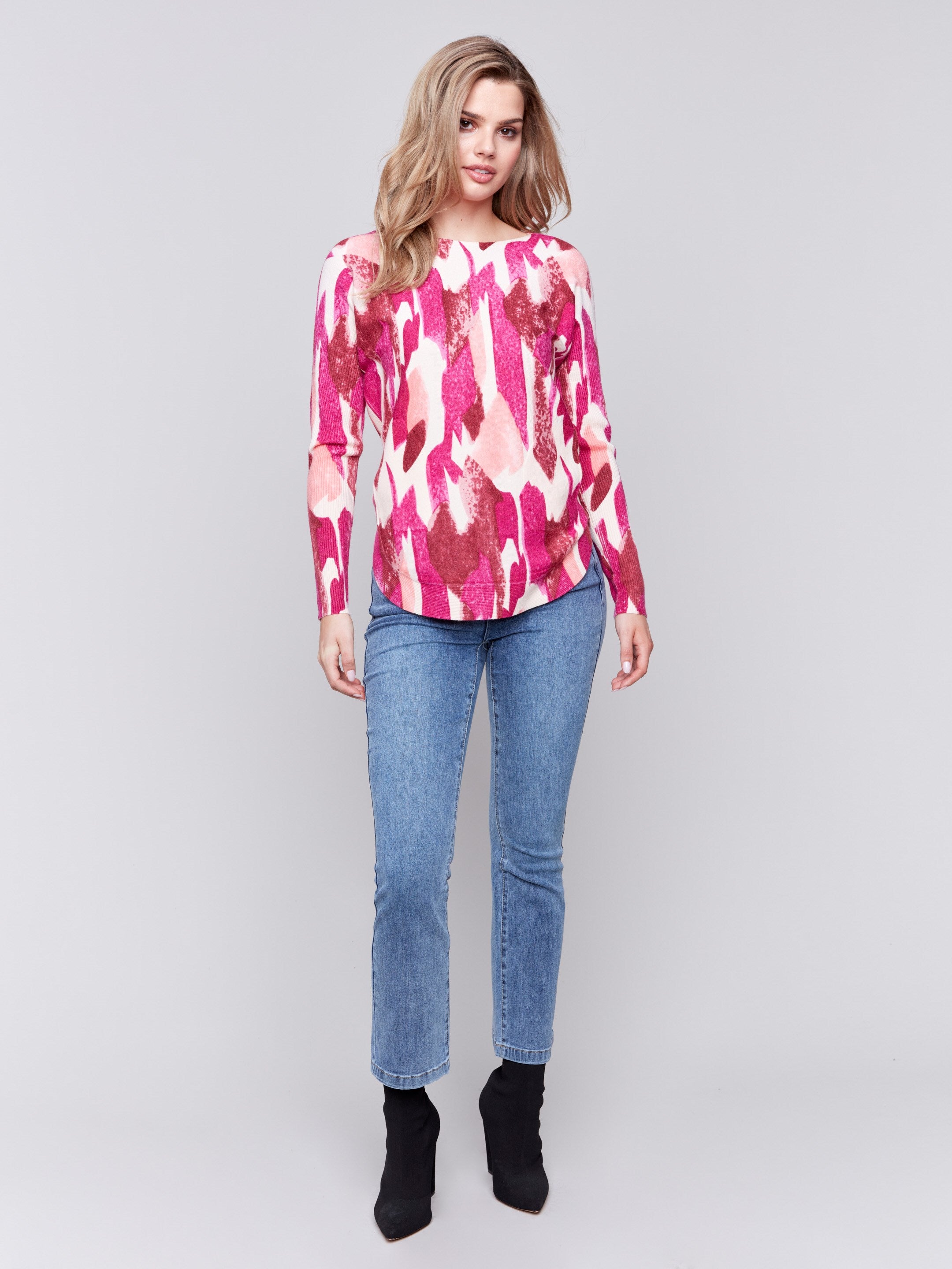 Fuchsia pink abstract print plush knit sweater with rounded hem and hidden pockets by Charlie B.