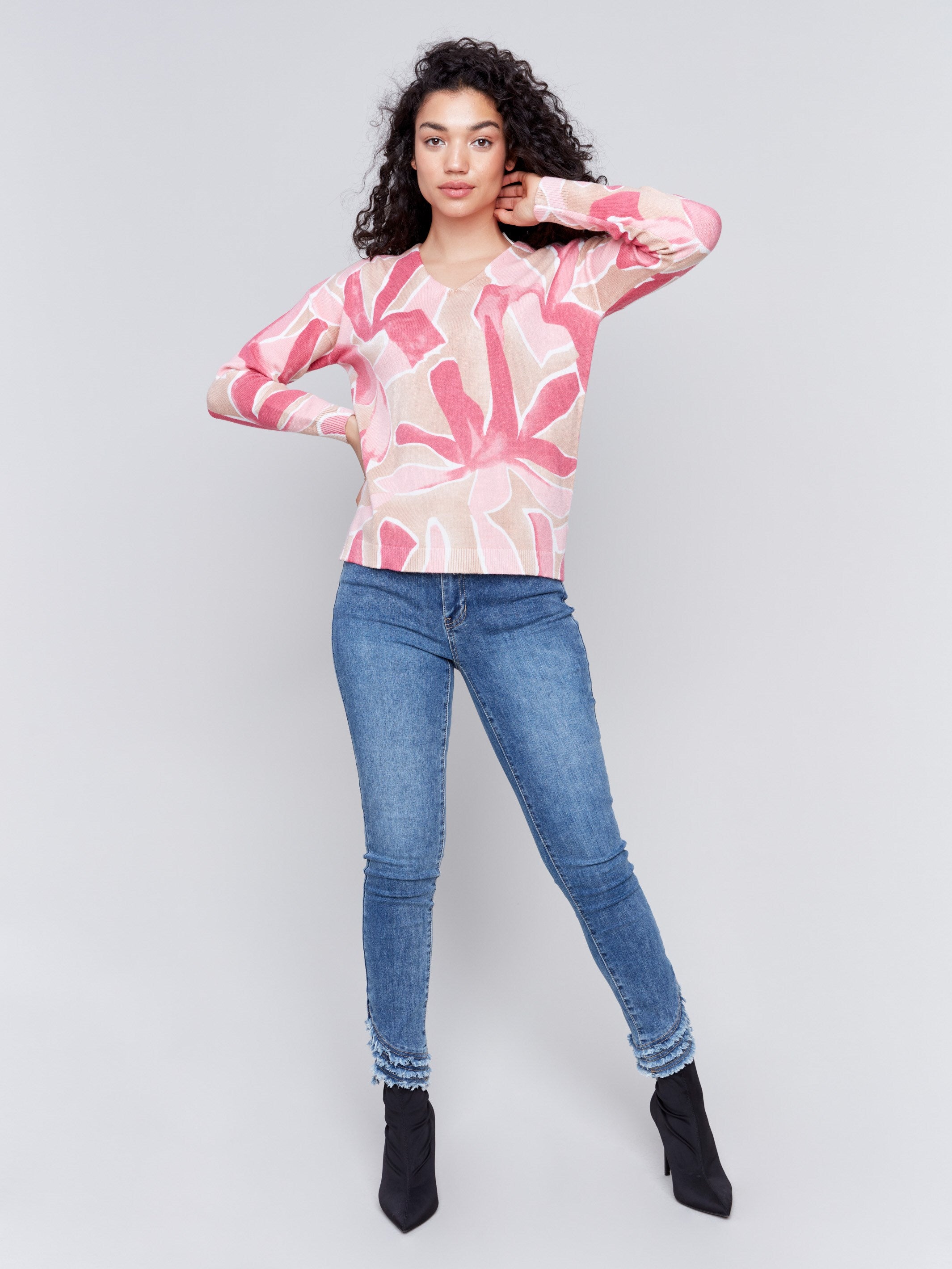 Raspberry pink V-neck sweater with an abstract print and drop shoulders by Charlie B.