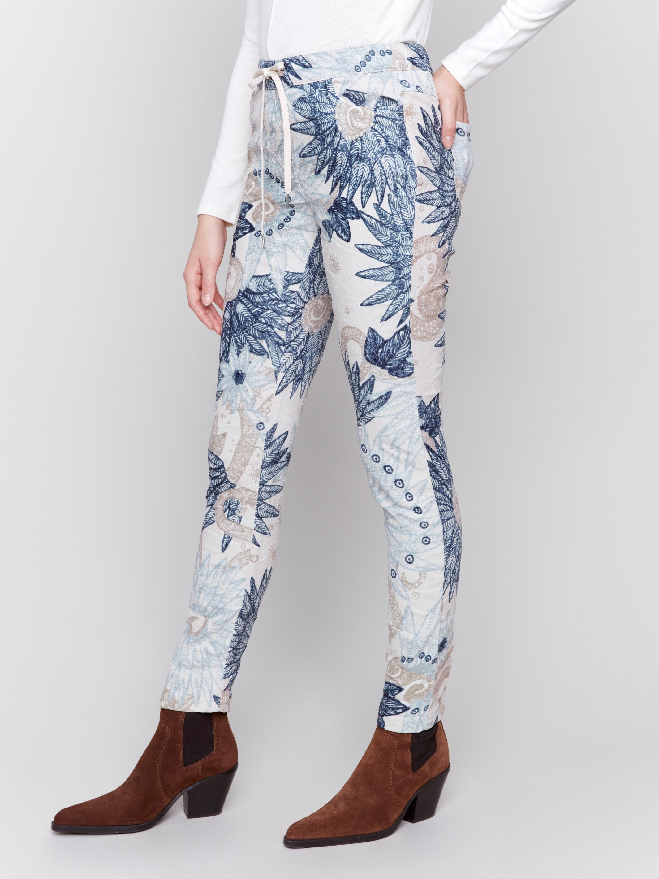 Jogger pants in a feather print design with a crinkled texture and pull-on waistband by Charlie B.