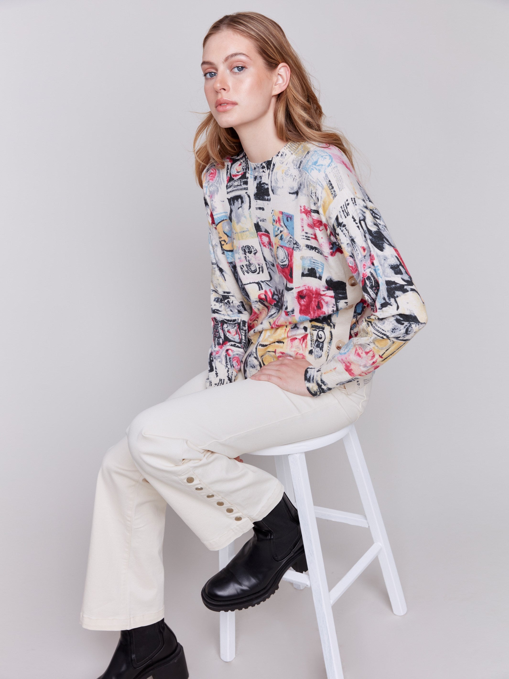 Multi-colored cartoon printed sweater with long sleeves, crew neck, and side button details by Charlie B.