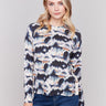 Tie dye printed sweater with long sleeves, crew neck, and side button details by Charlie B.