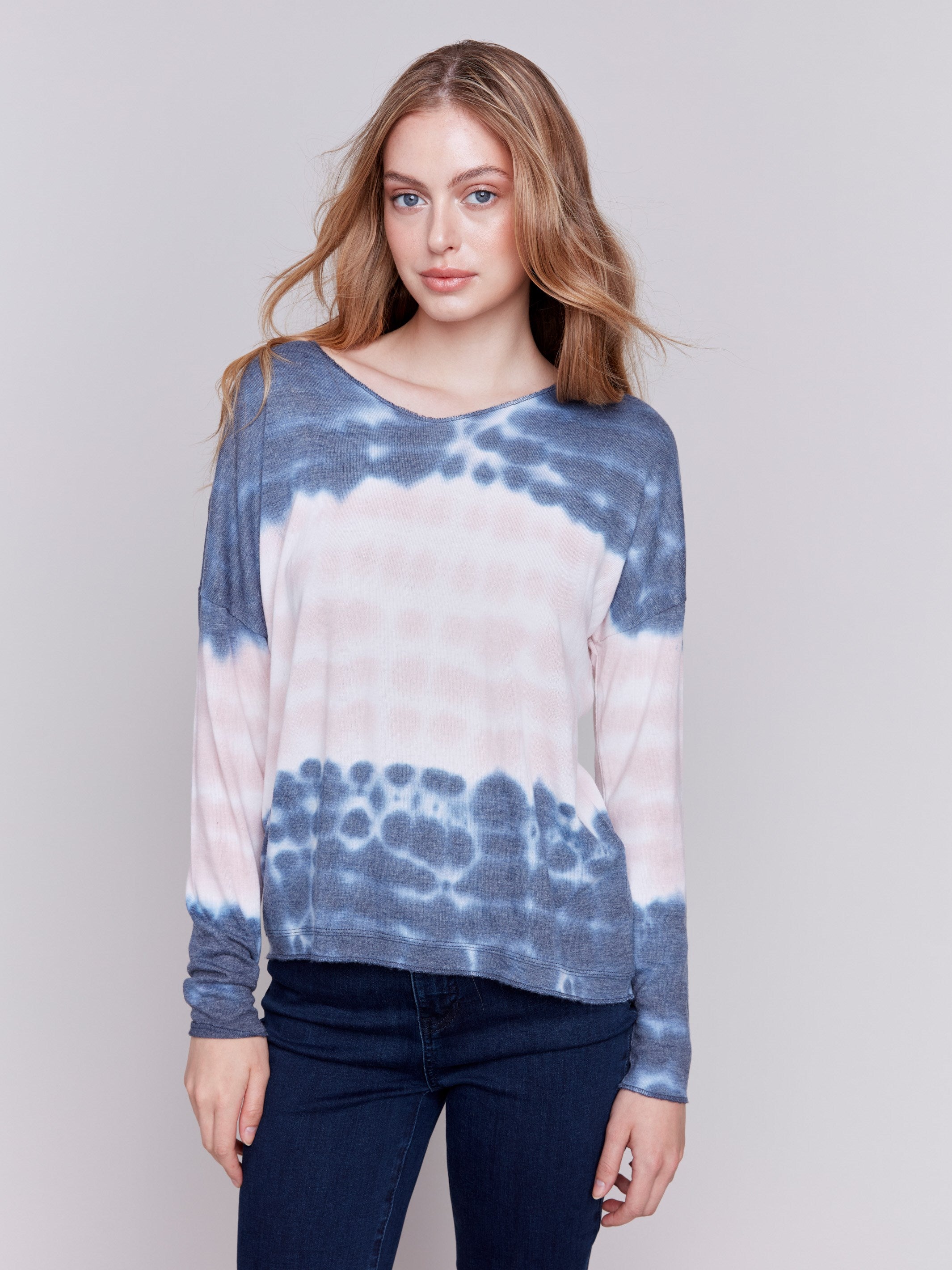 Long-sleeve V-neck knit top with a unique tie-dye wave pattern in blue by Charlie B.