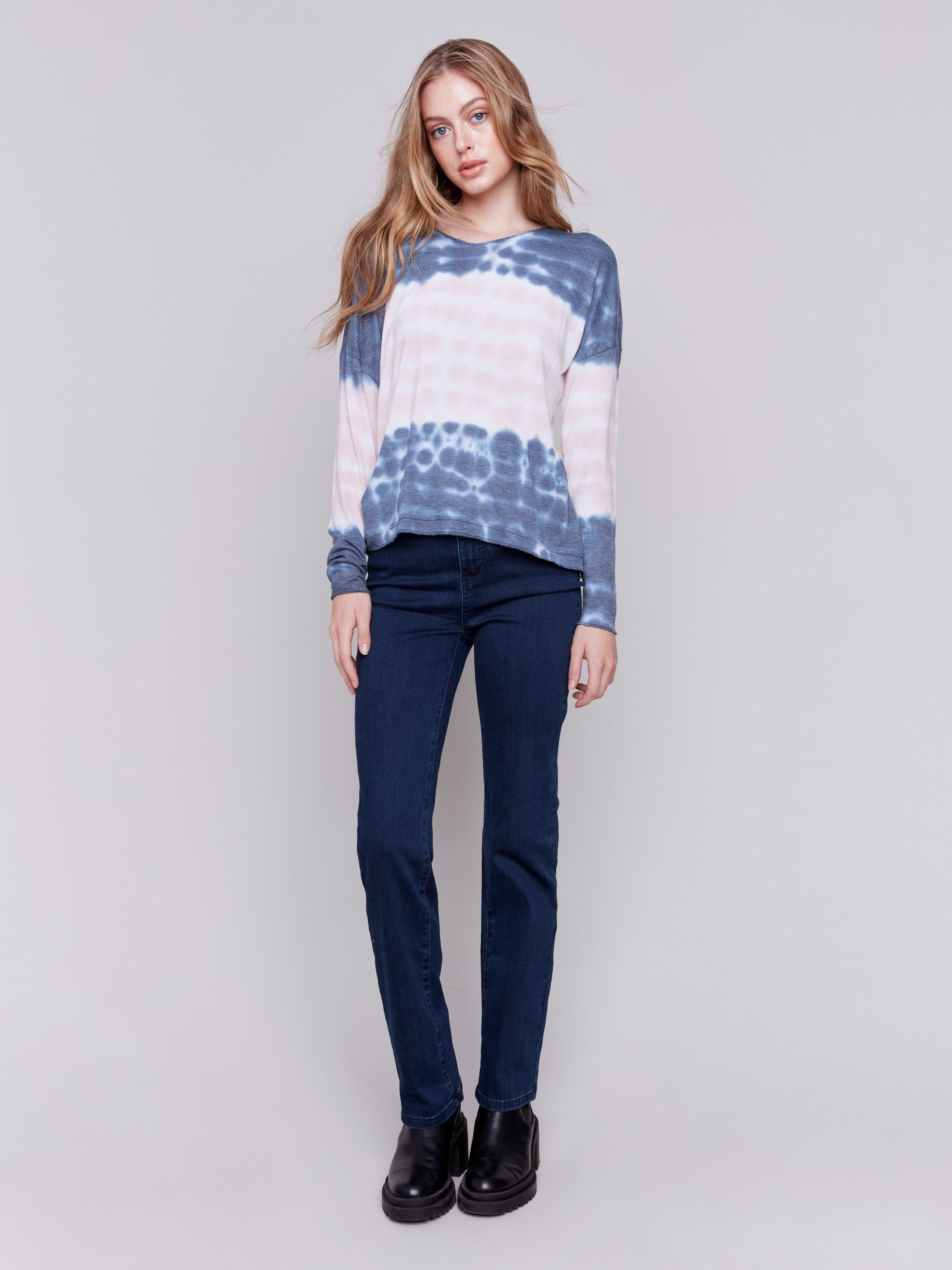 Long-sleeve V-neck knit top with a unique tie-dye wave pattern in blue by Charlie B.